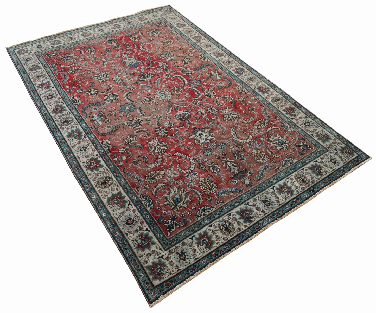 A vintage Persian Tabriz rug featuring a central medallion and intricate floral patterns in red.
