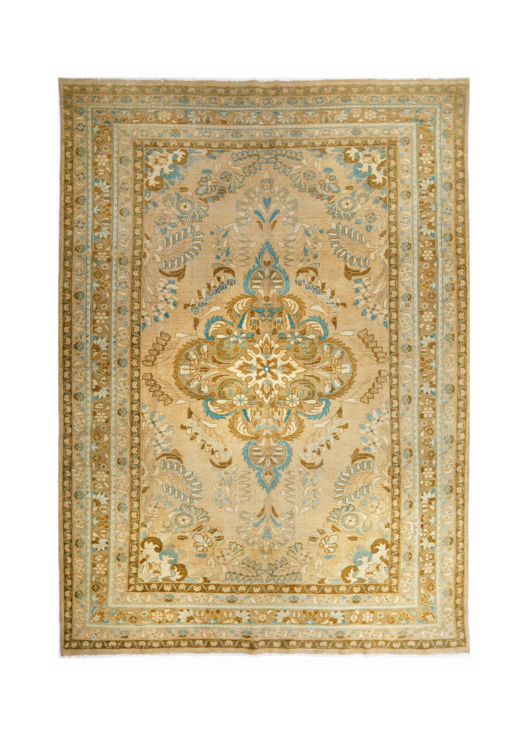 A vintage Persian Tabriz rug featuring a central floral medallion in beige and blue tones.