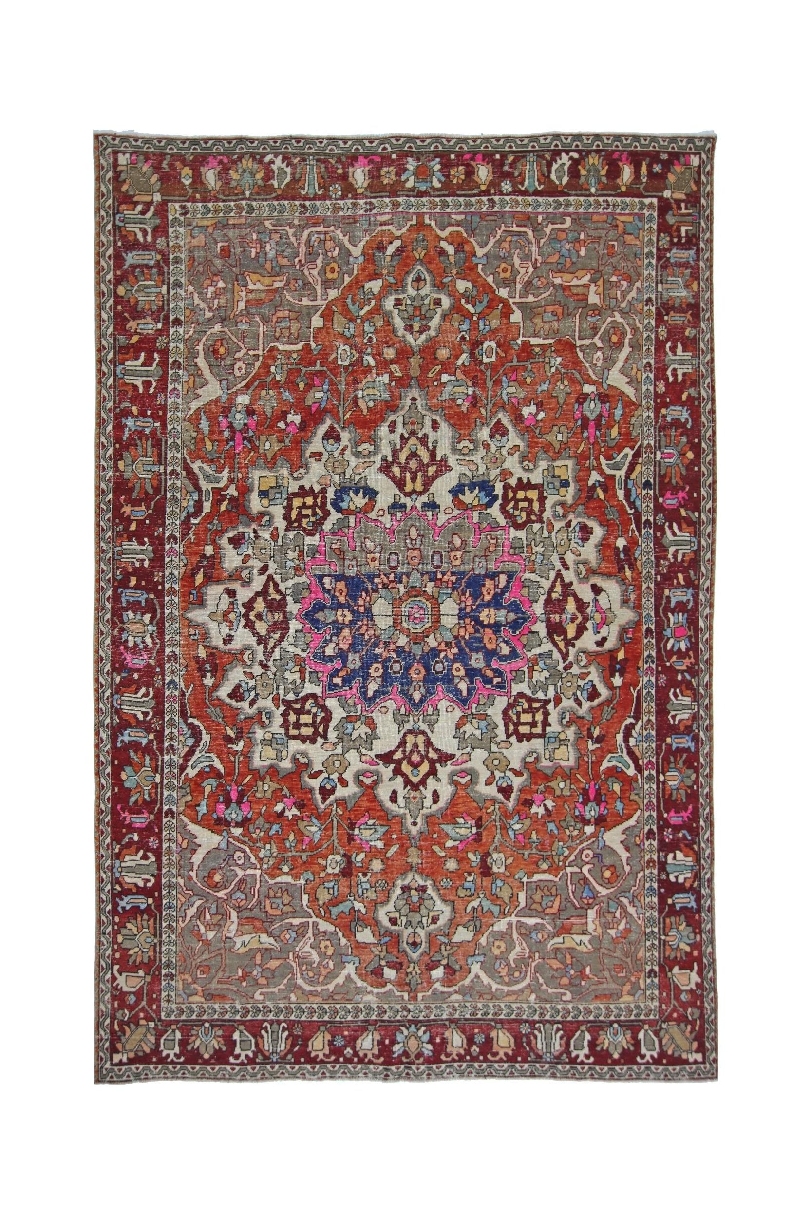 A vintage Persian Tabriz rug featuring a central floral medallion on a red and cream field.