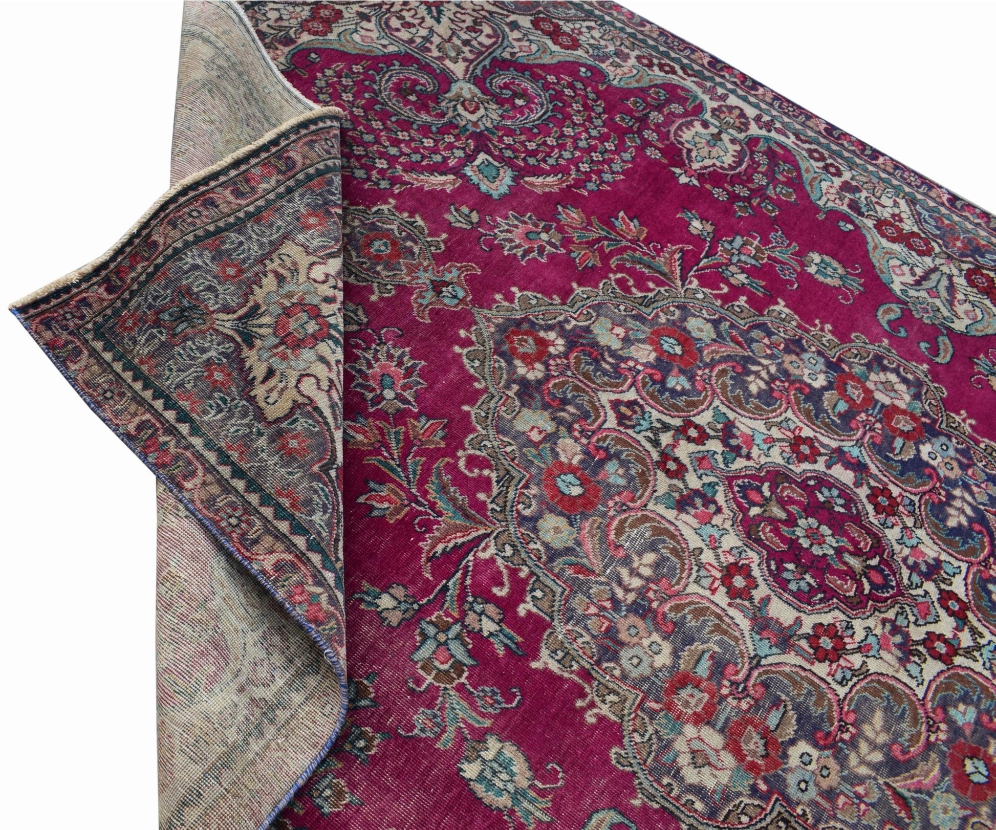 A vintage Persian Tabriz rug featuring a magenta field with an intricate floral medallion design.