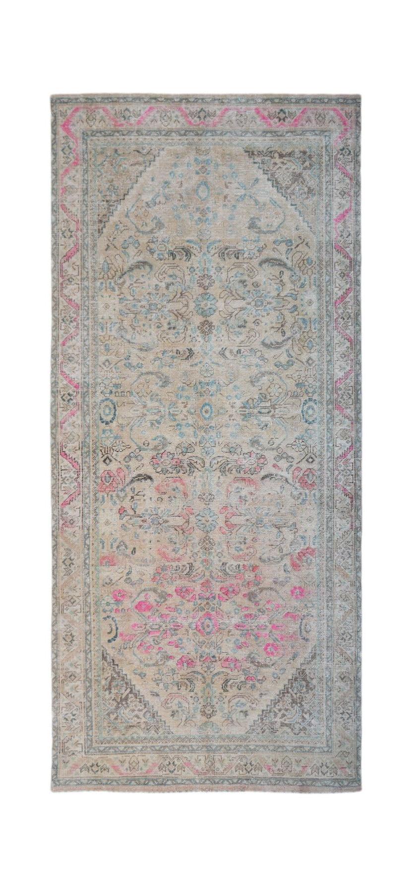 A vintage Persian Tabriz rug featuring a faded floral pattern in pink, blue, and beige tones.