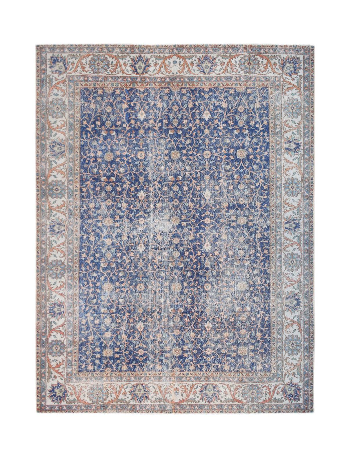 A vintage Persian Tabriz rug featuring a distressed blue floral pattern with a decorative border.