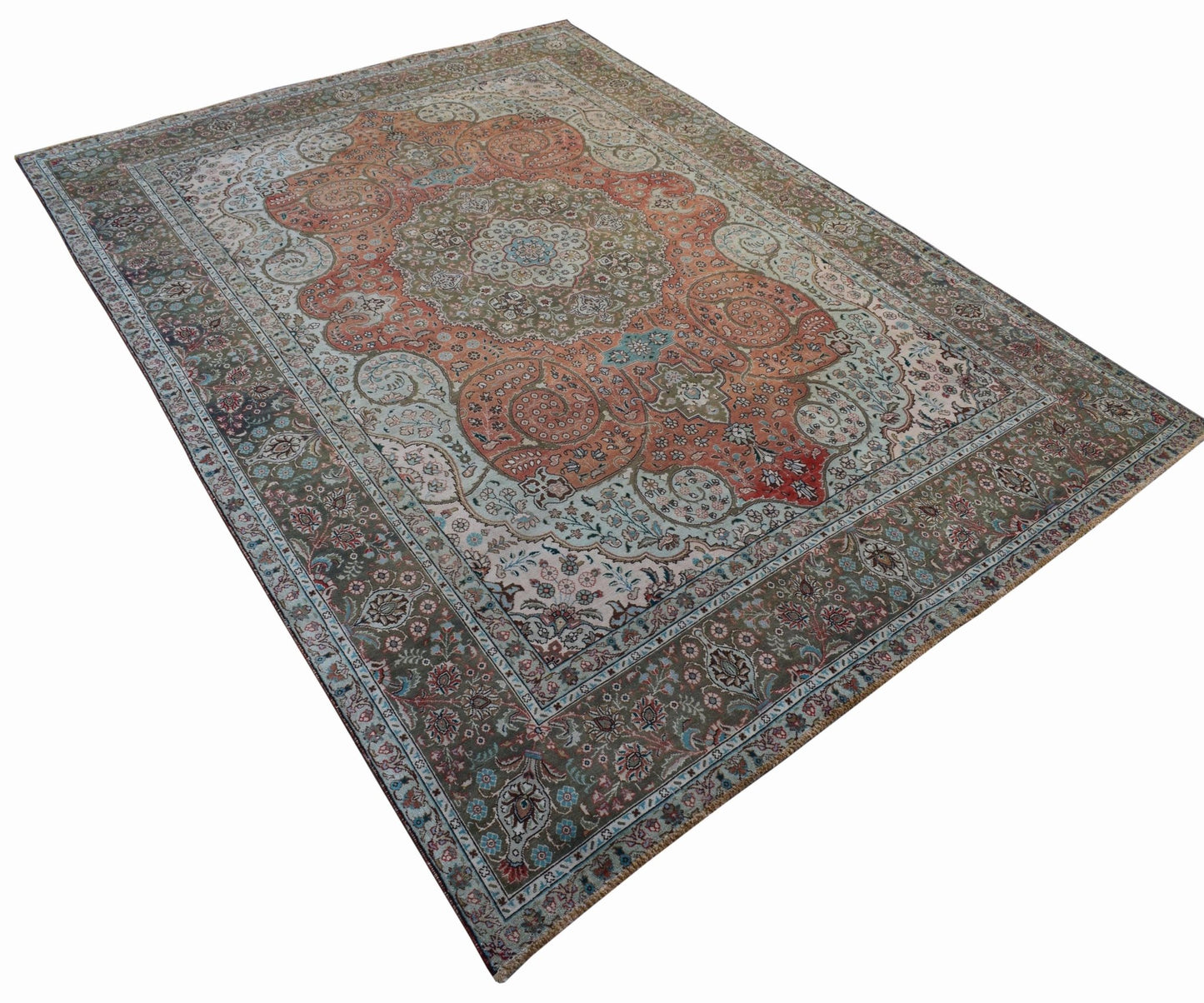 A vintage handwoven Persian Tabriz rug featuring intricate floral patterns in orange and green.