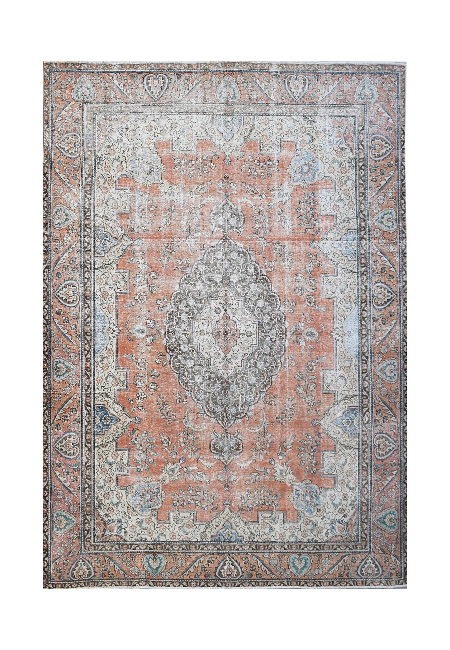 A vintage Persian Tabriz rug featuring a central medallion and floral patterns in orange and grey.