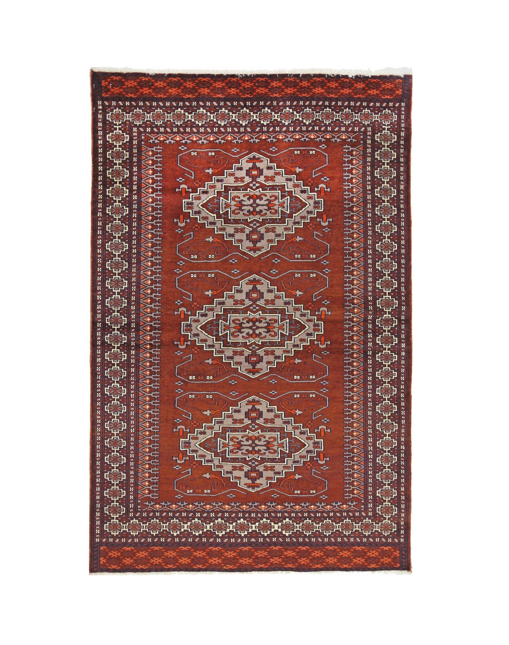 A vintage Pakistani Princess Bokhara rug featuring three geometric medallions on a rust red field.