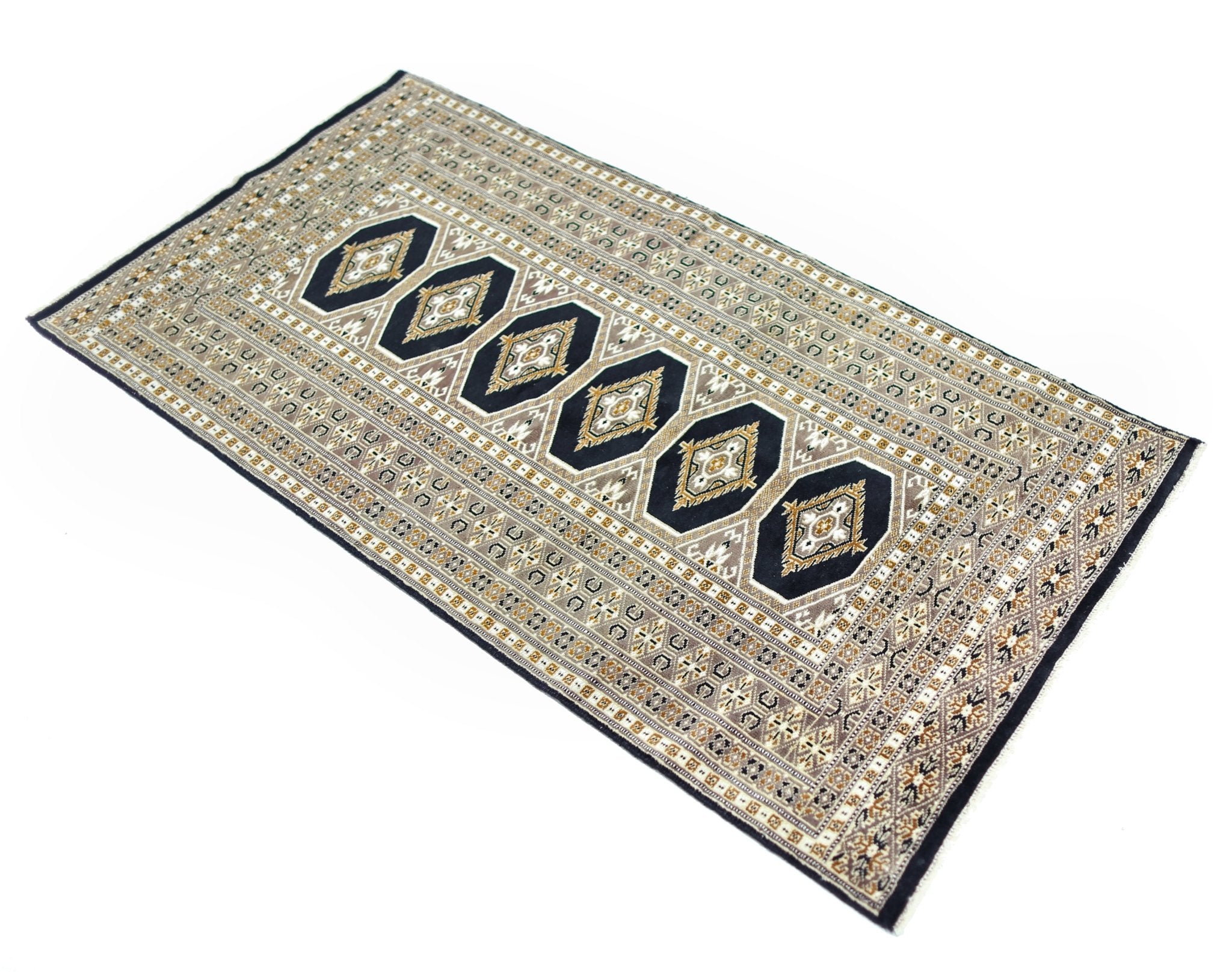 A vintage Pakistani Princess Bokhara rug featuring a repeating diamond pattern on a dark background.