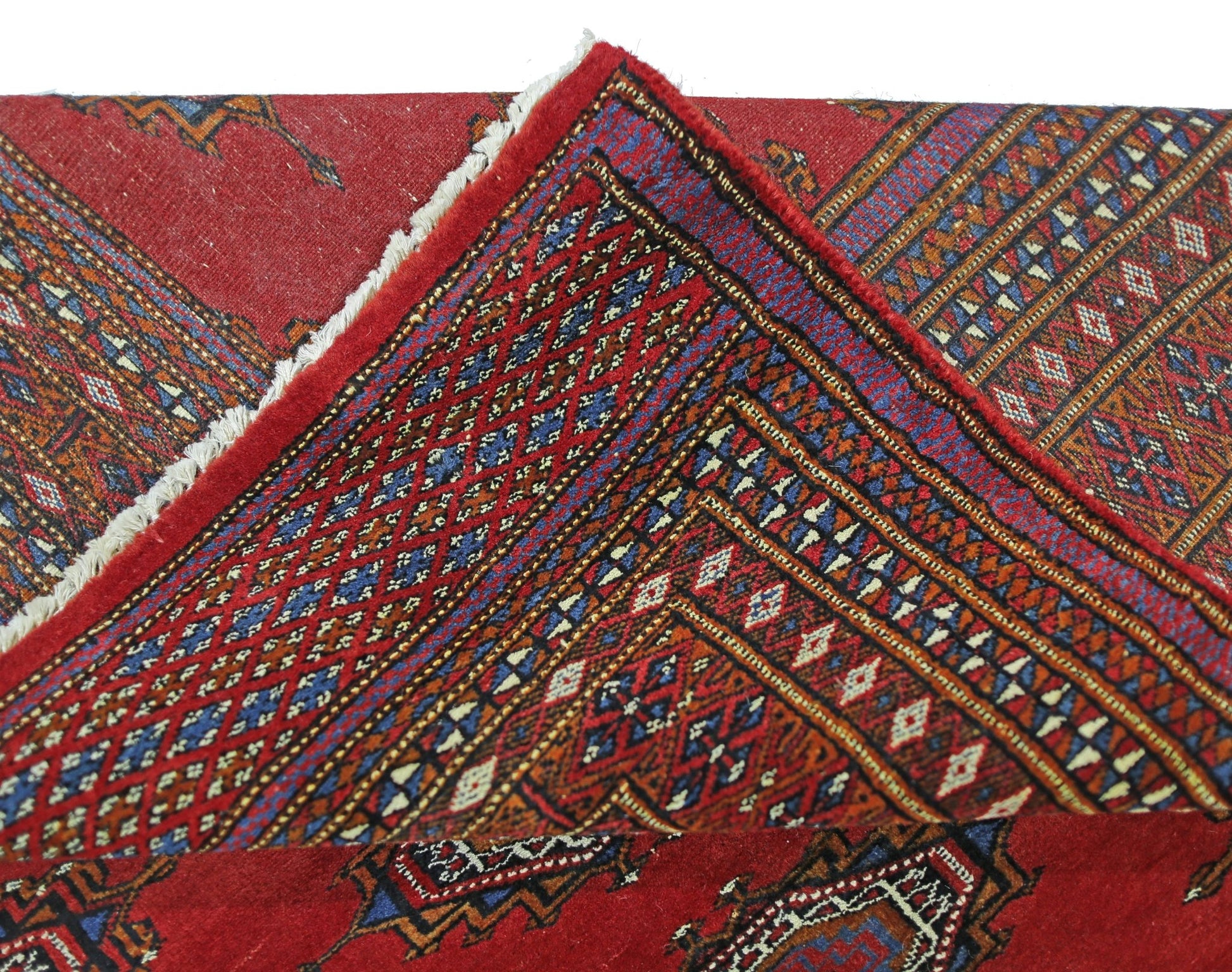 A vintage Pakistani Princess Bokhara rug featuring a red field with intricate geometric patterns.