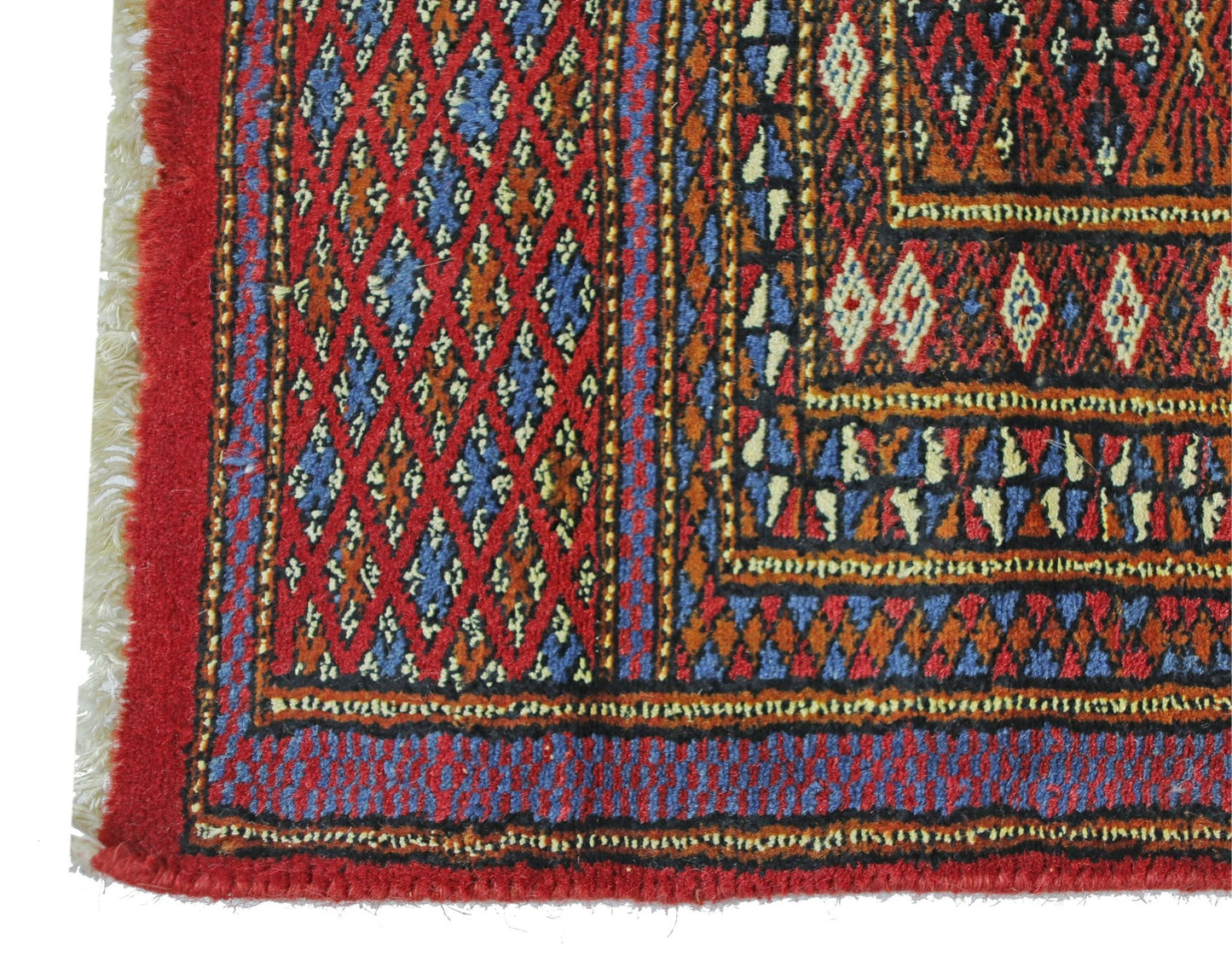 A vintage Pakistani Princess Bokhara rug featuring a geometric diamond pattern in red and blue.