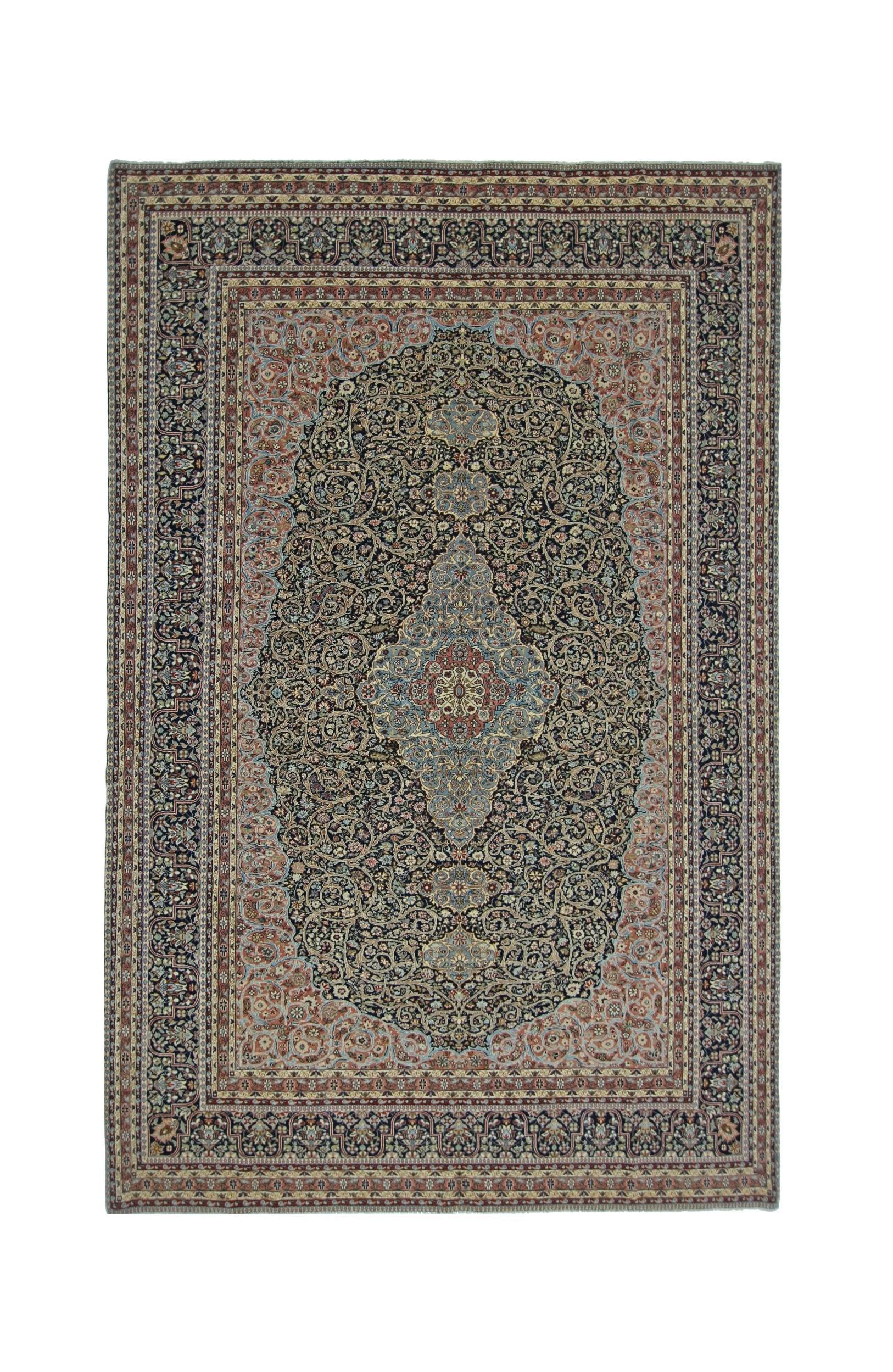A vintage Persian Tabriz rug featuring an intricate floral medallion on a dark navy field.