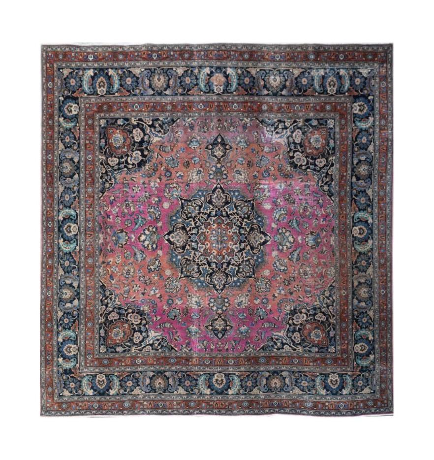 A square vintage Persian Bidjar rug featuring a central floral medallion on a pink field.