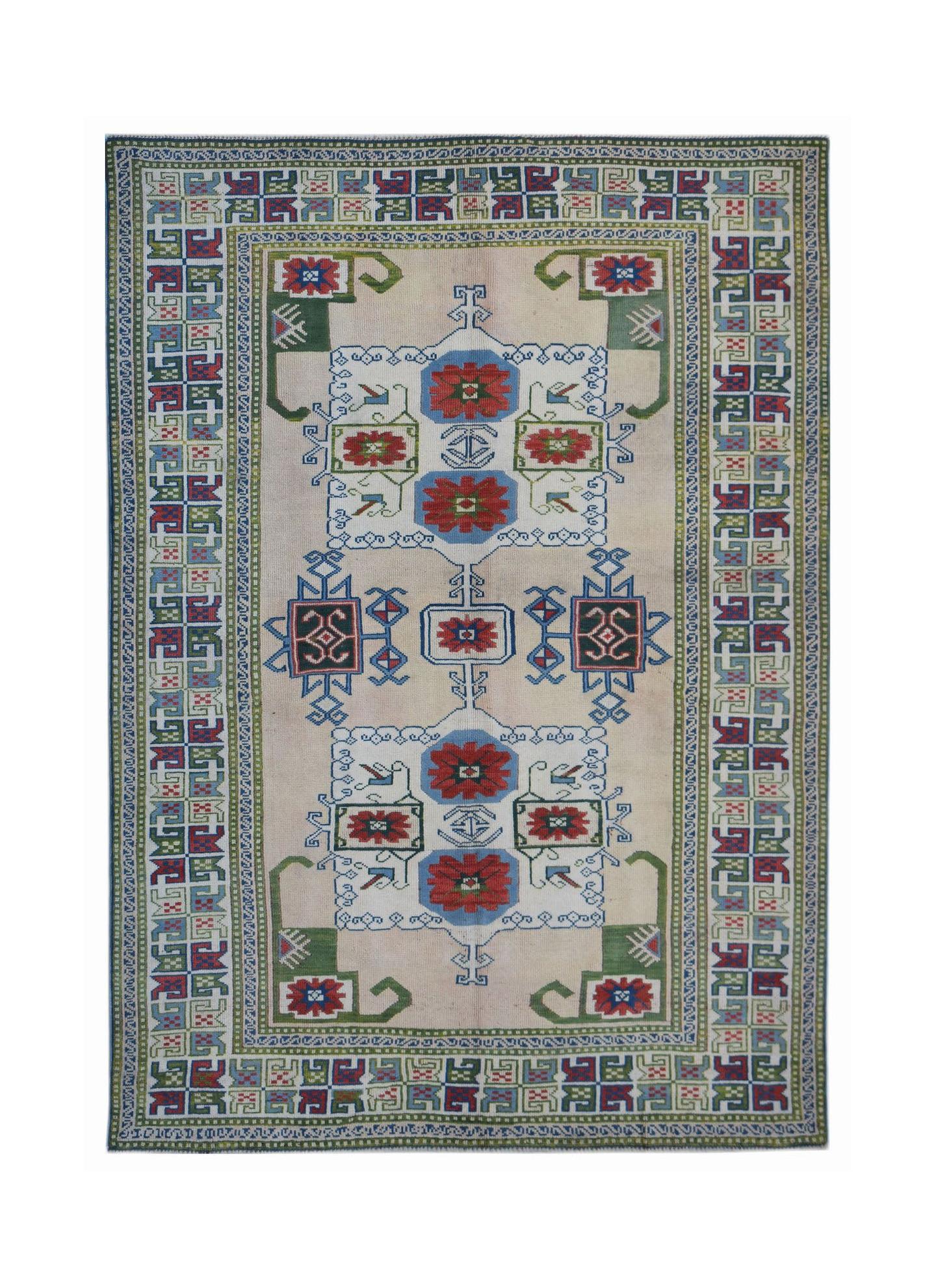 A vintage Turkish Oushak rug featuring a traditional geometric pattern in red, blue, and green.