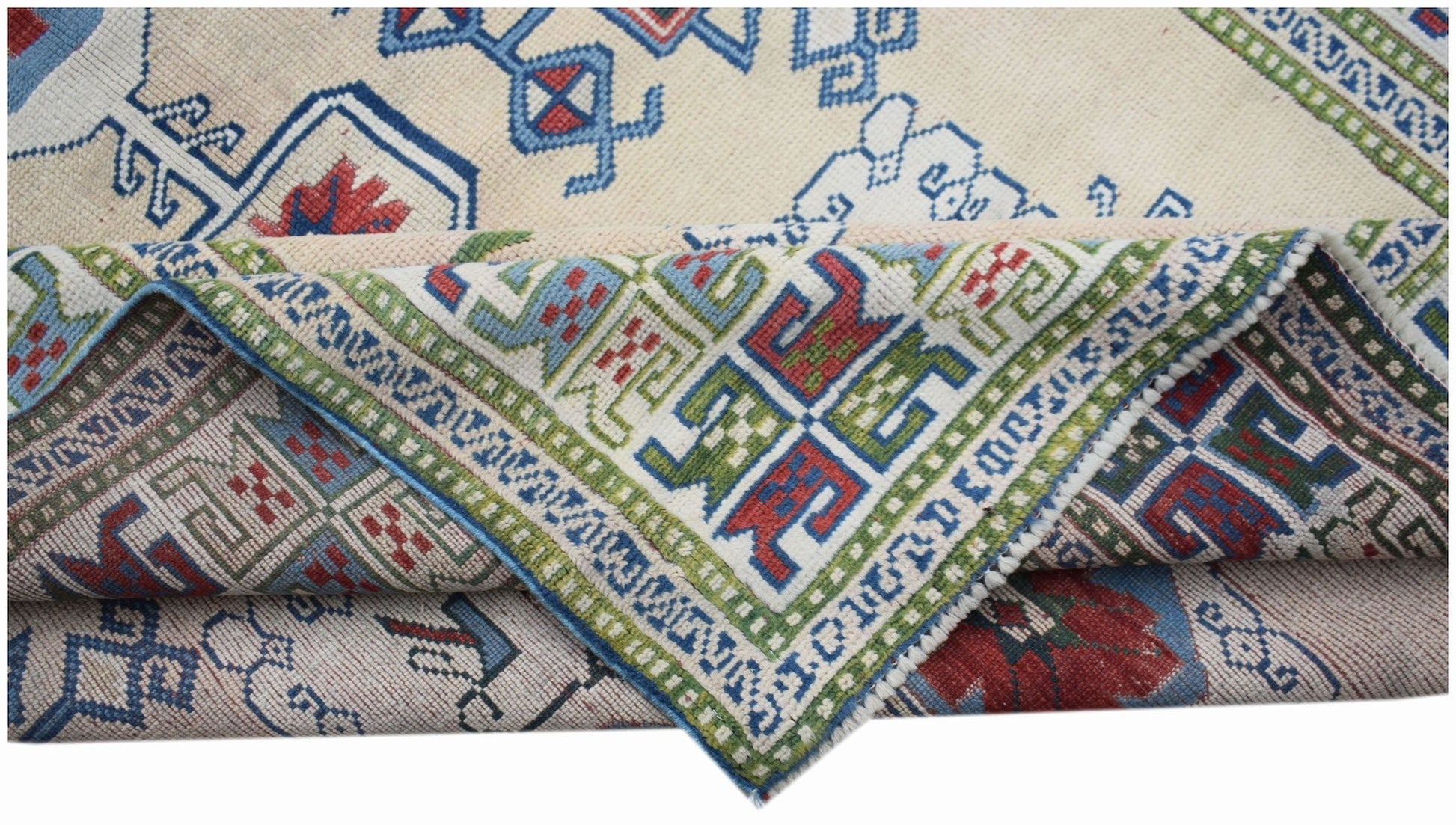 A vintage Turkish Oushak rug featuring a traditional geometric pattern in blue, red, and green.