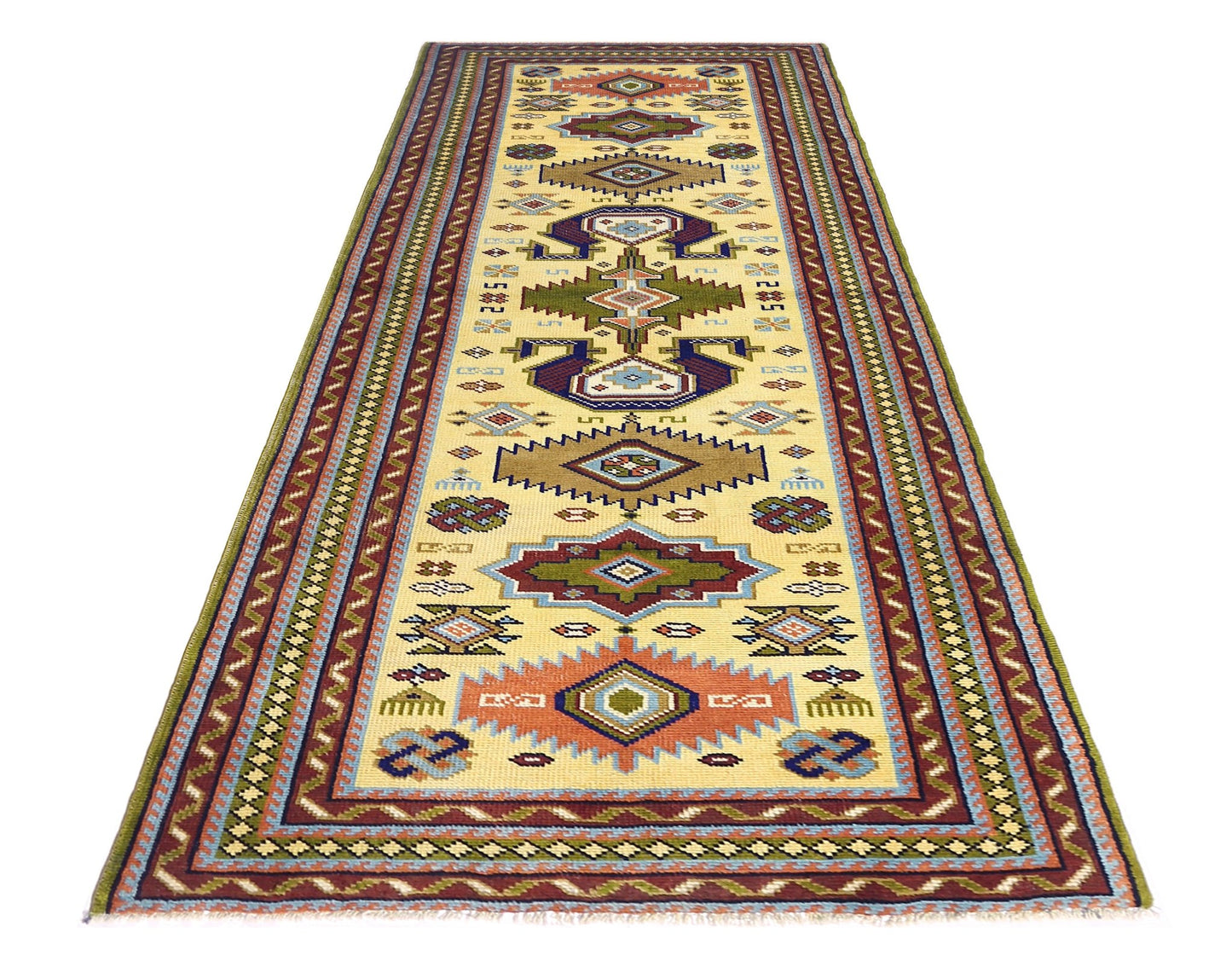 A vintage handmade Turkish runner rug featuring geometric patterns in earthy tones on a cream base.