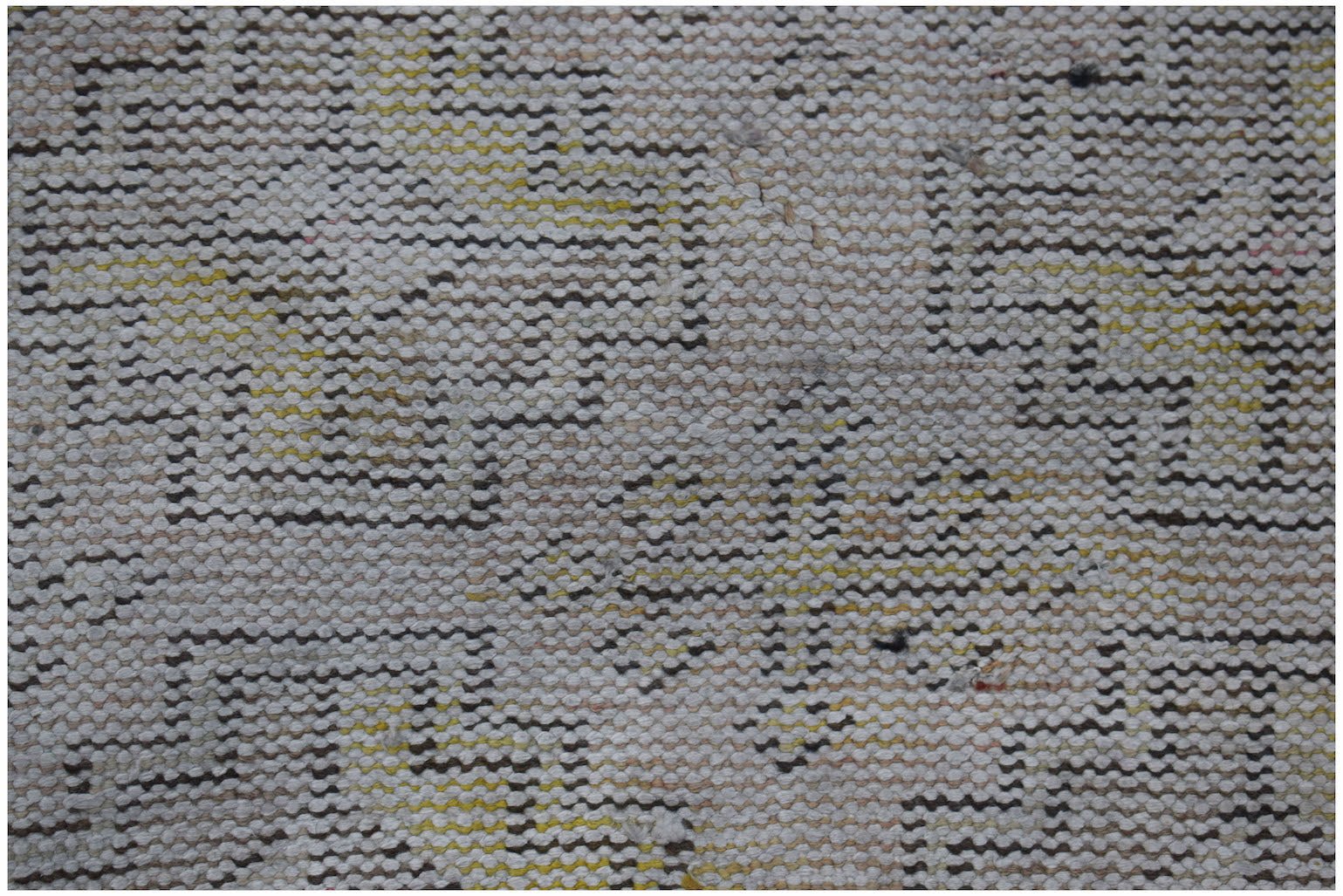 A close-up of a vintage Turkish Isparta runner featuring a faded geometric pattern in wool.