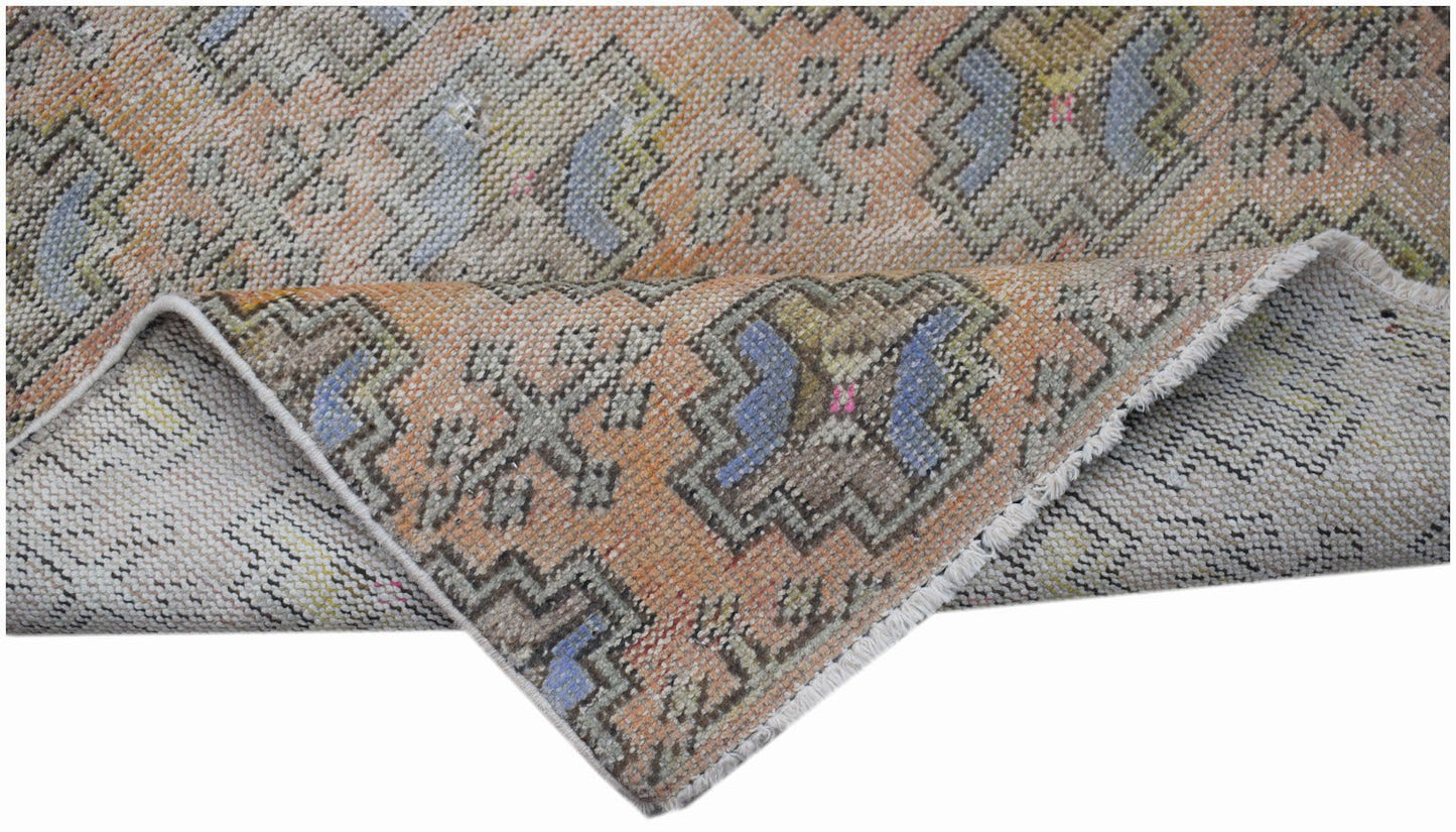 A vintage handwoven Turkish Isparta runner featuring geometric patterns in orange and blue tones.