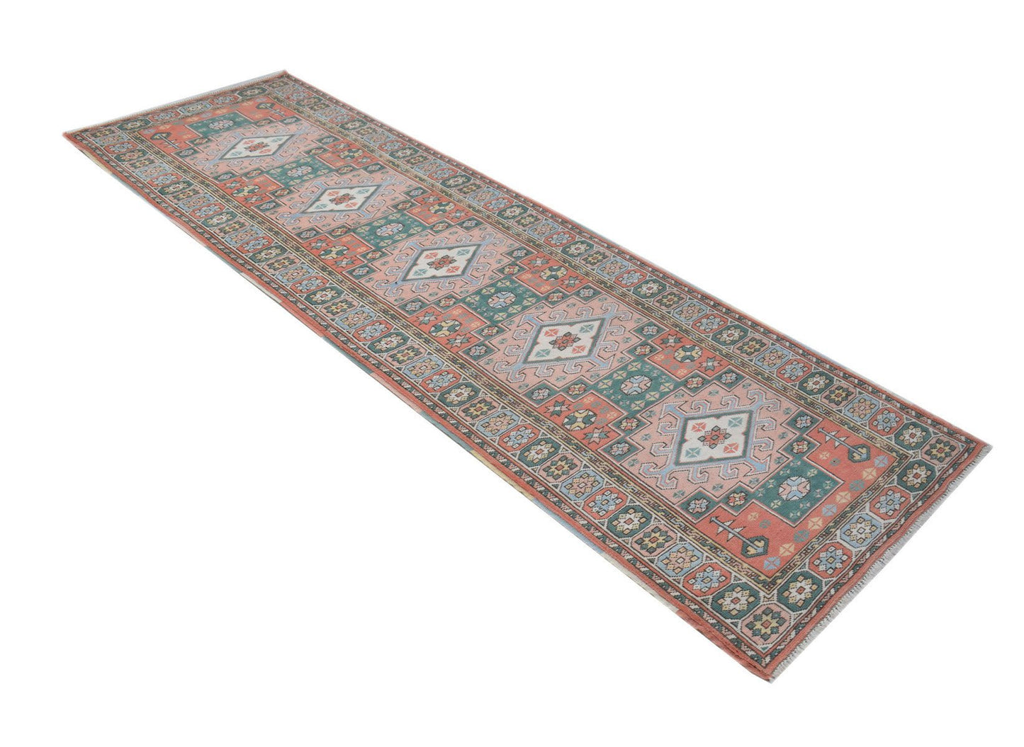 A handwoven vintage Turkish Kars runner featuring geometric patterns in muted red and green tones.