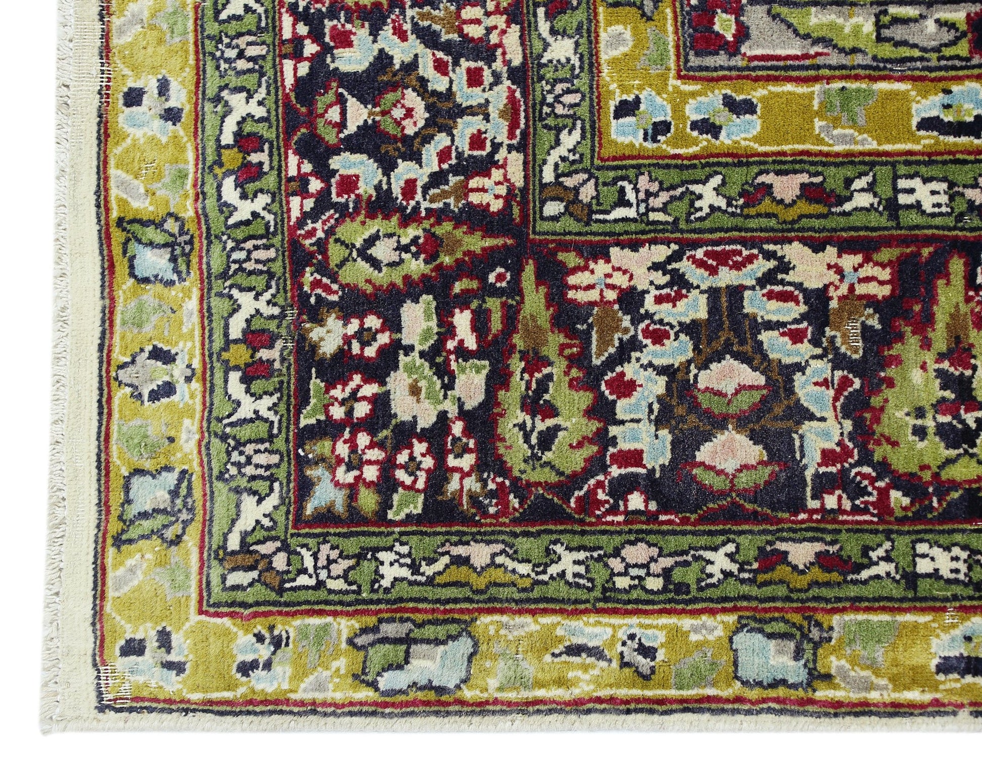 A vintage Turkish Kayseri rug featuring intricate floral patterns in green, red, and dark blue.
