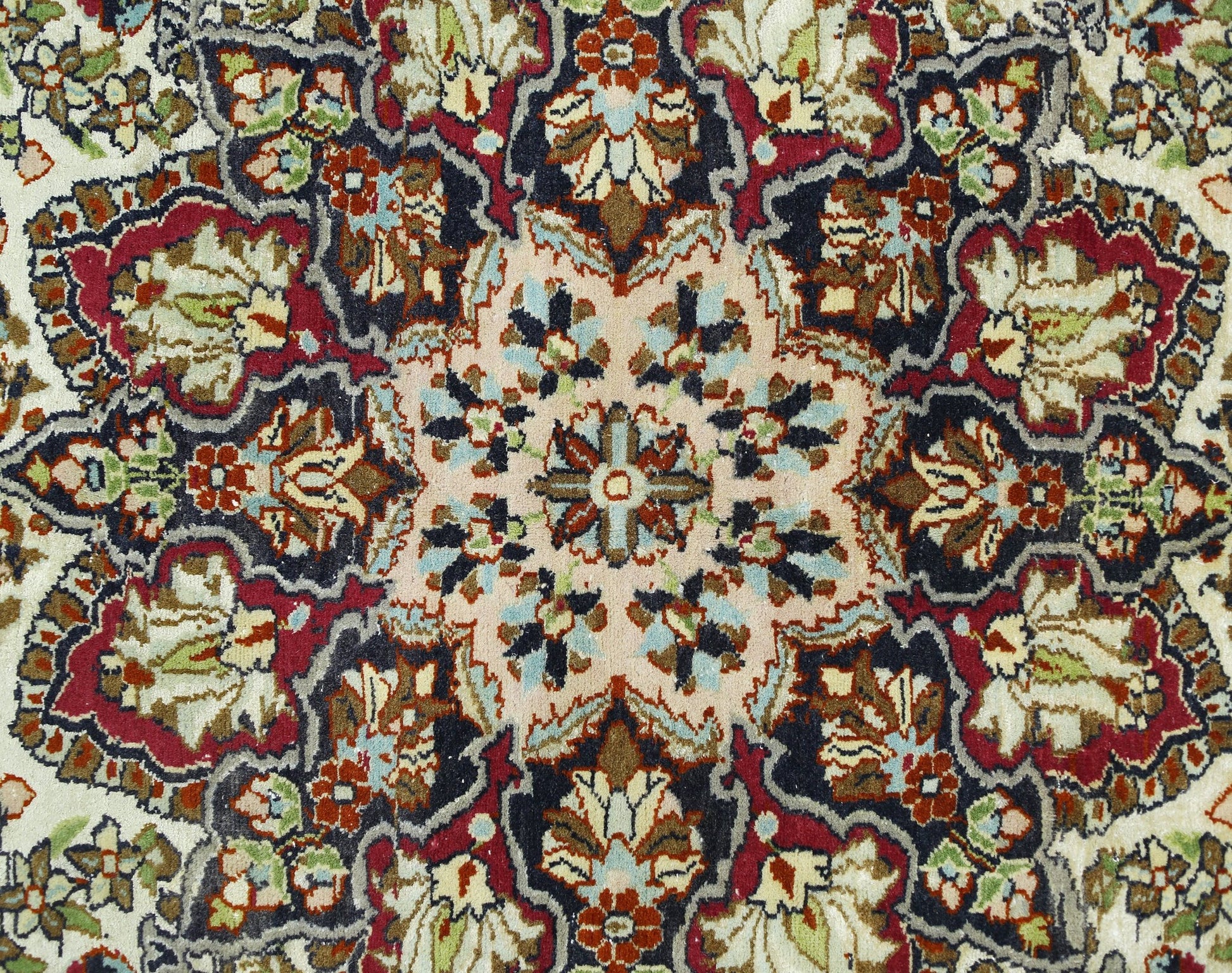 A vintage Turkish Kayseri rug featuring a detailed floral medallion pattern in red and blue tones.