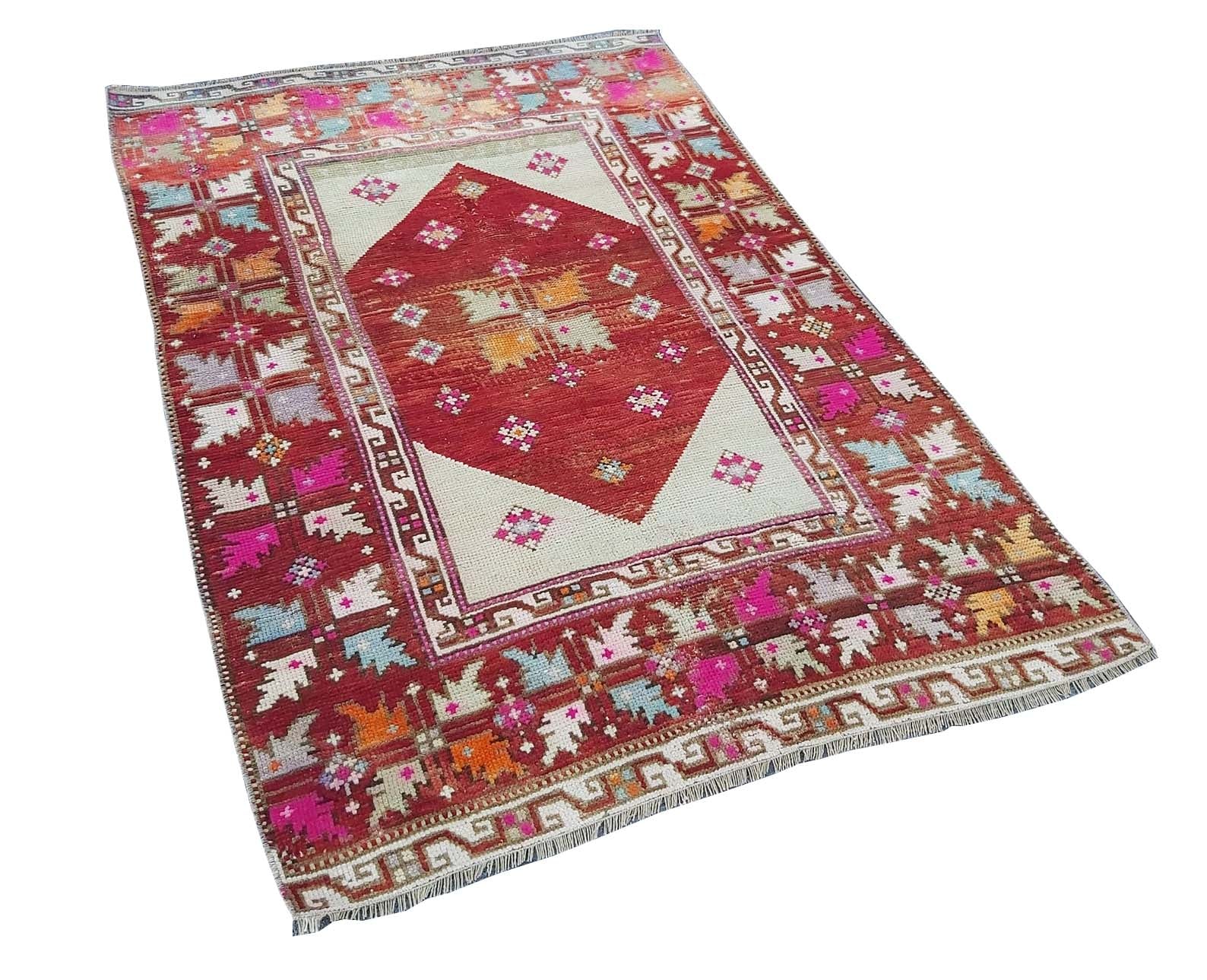 A vintage handmade Turkish Kula rug featuring a red diamond medallion and colorful geometric motifs.