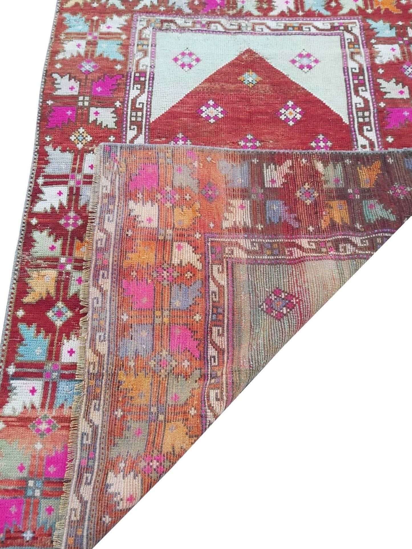 A vintage handmade Turkish Kula rug featuring geometric patterns in vibrant colors.