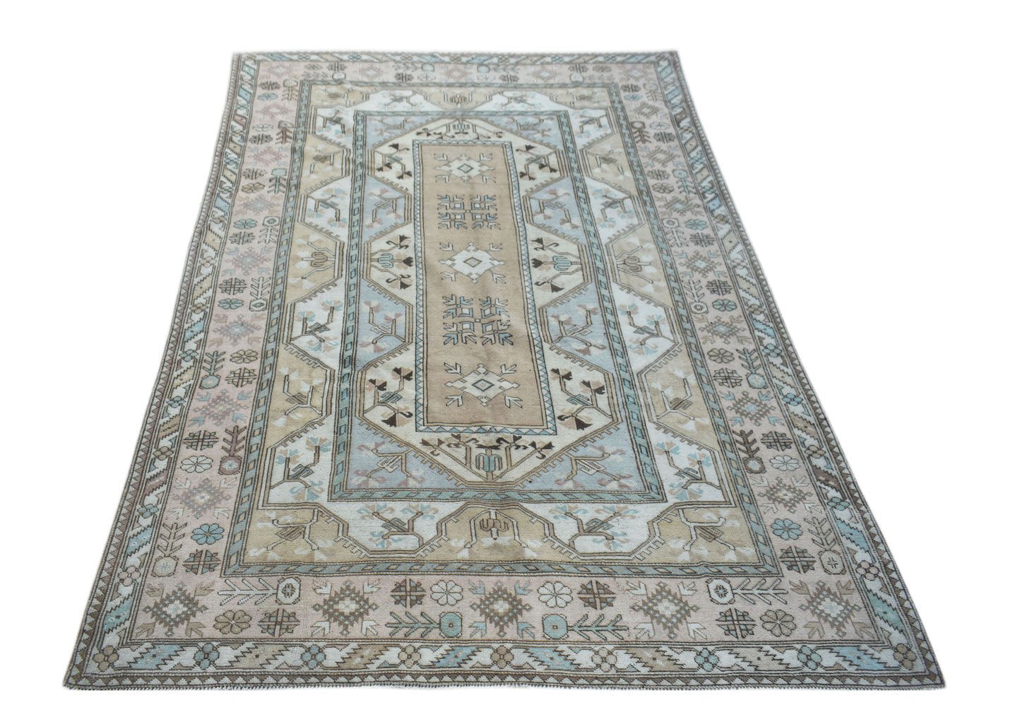 A vintage handmade Turkish Milas rug featuring a traditional geometric pattern in beige and blue.