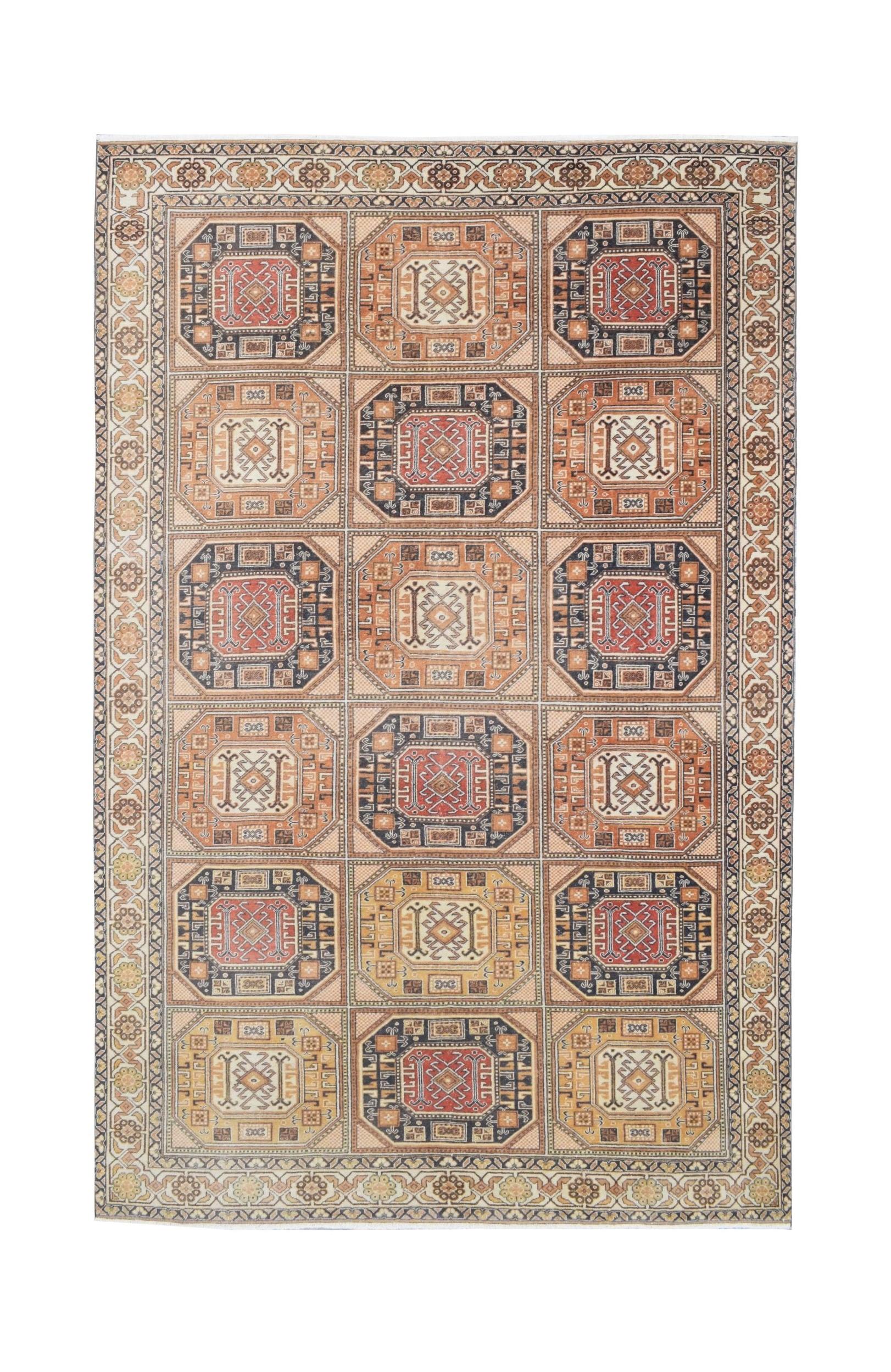 A vintage handmade Turkish Oushak rug featuring a grid of geometric medallions in warm earth tones.
