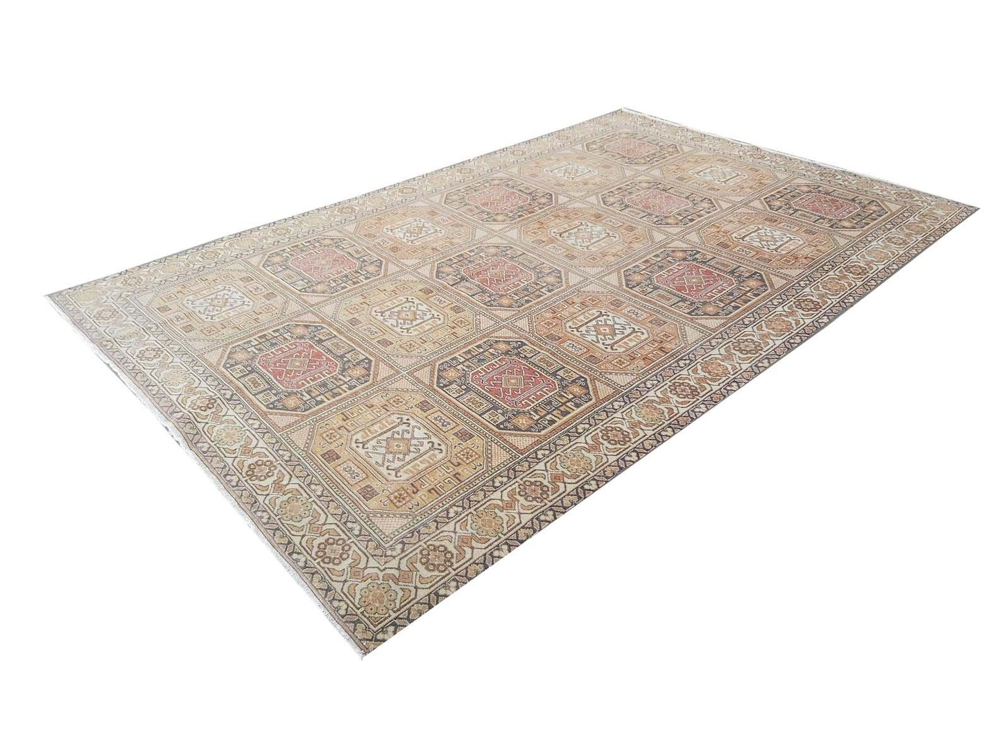 A vintage handmade Turkish Oushak rug featuring a repeating geometric medallion pattern in wool.