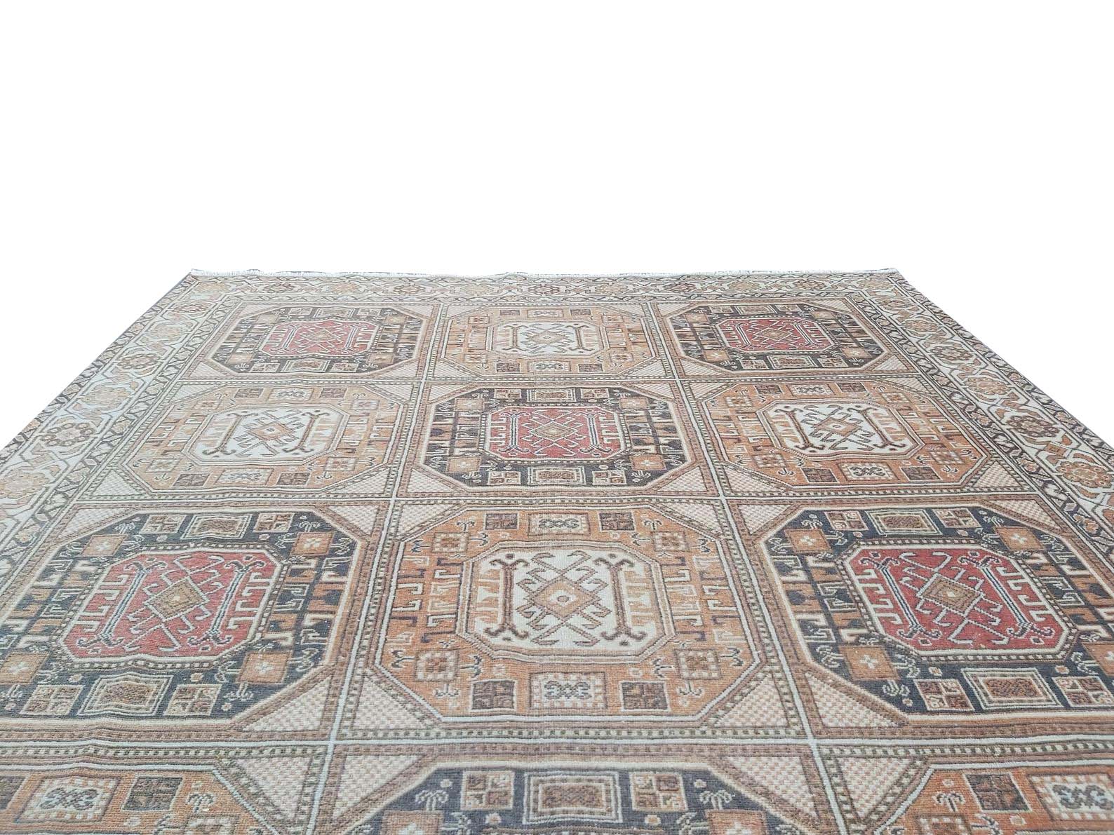 A vintage handmade Turkish Oushak rug featuring a geometric grid of octagonal medallions.
