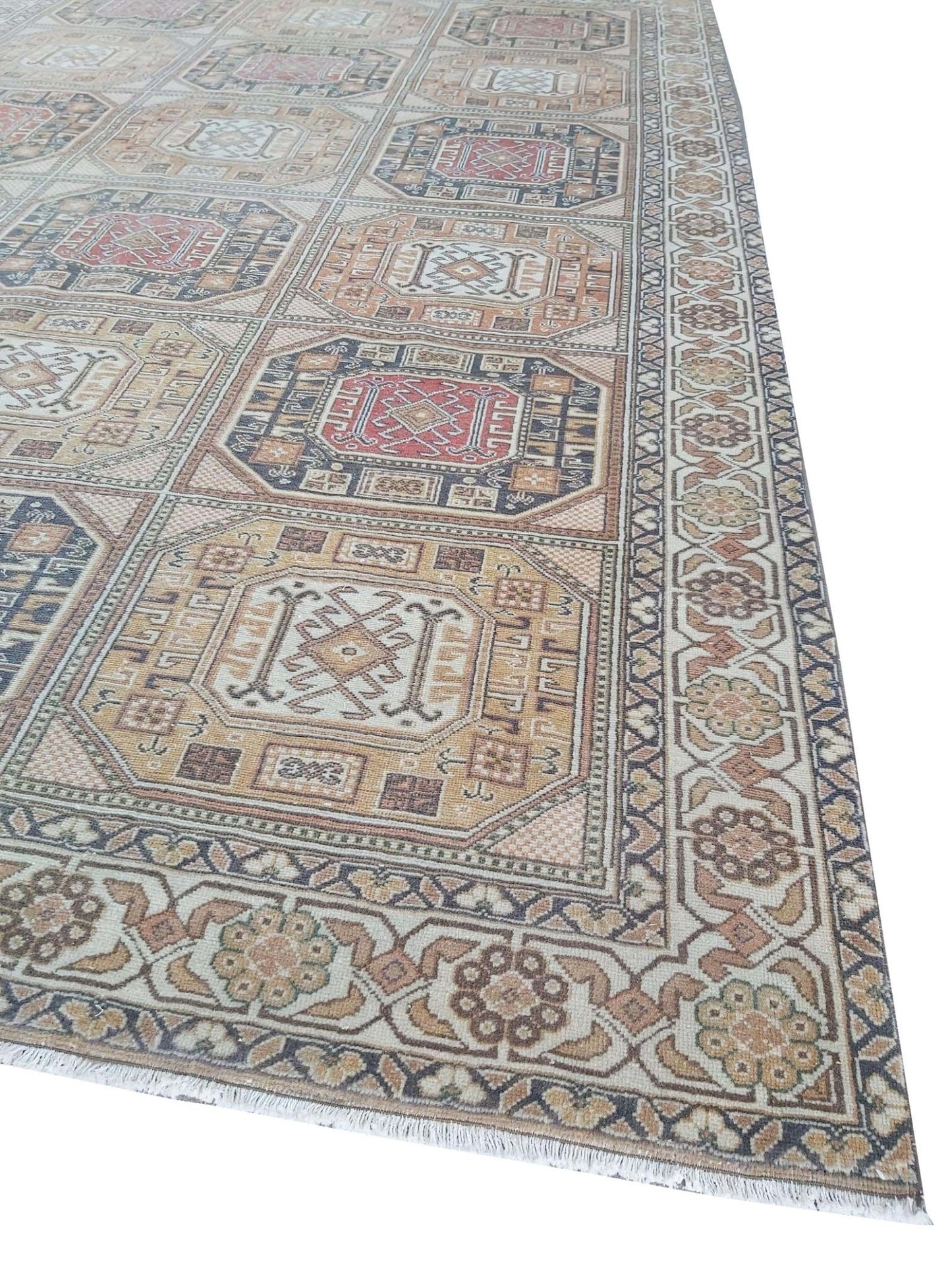 A vintage Turkish Oushak rug featuring a geometric grid pattern in muted earth tones.