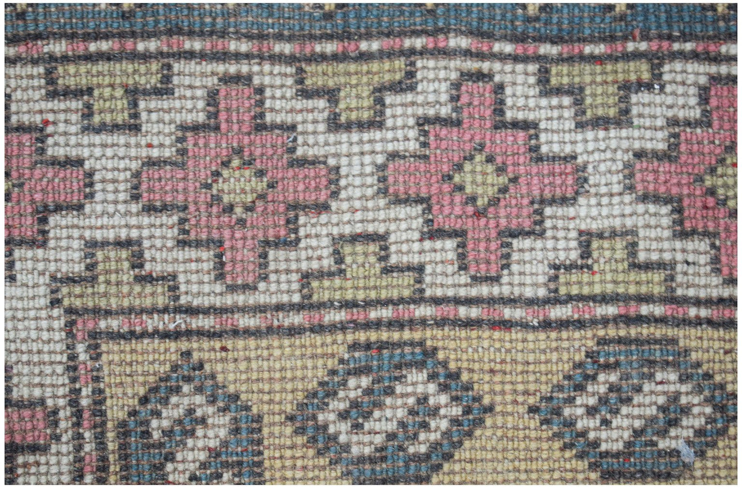 Vintage Turkish Milas rug with geometric patterns in pink, green, and blue.