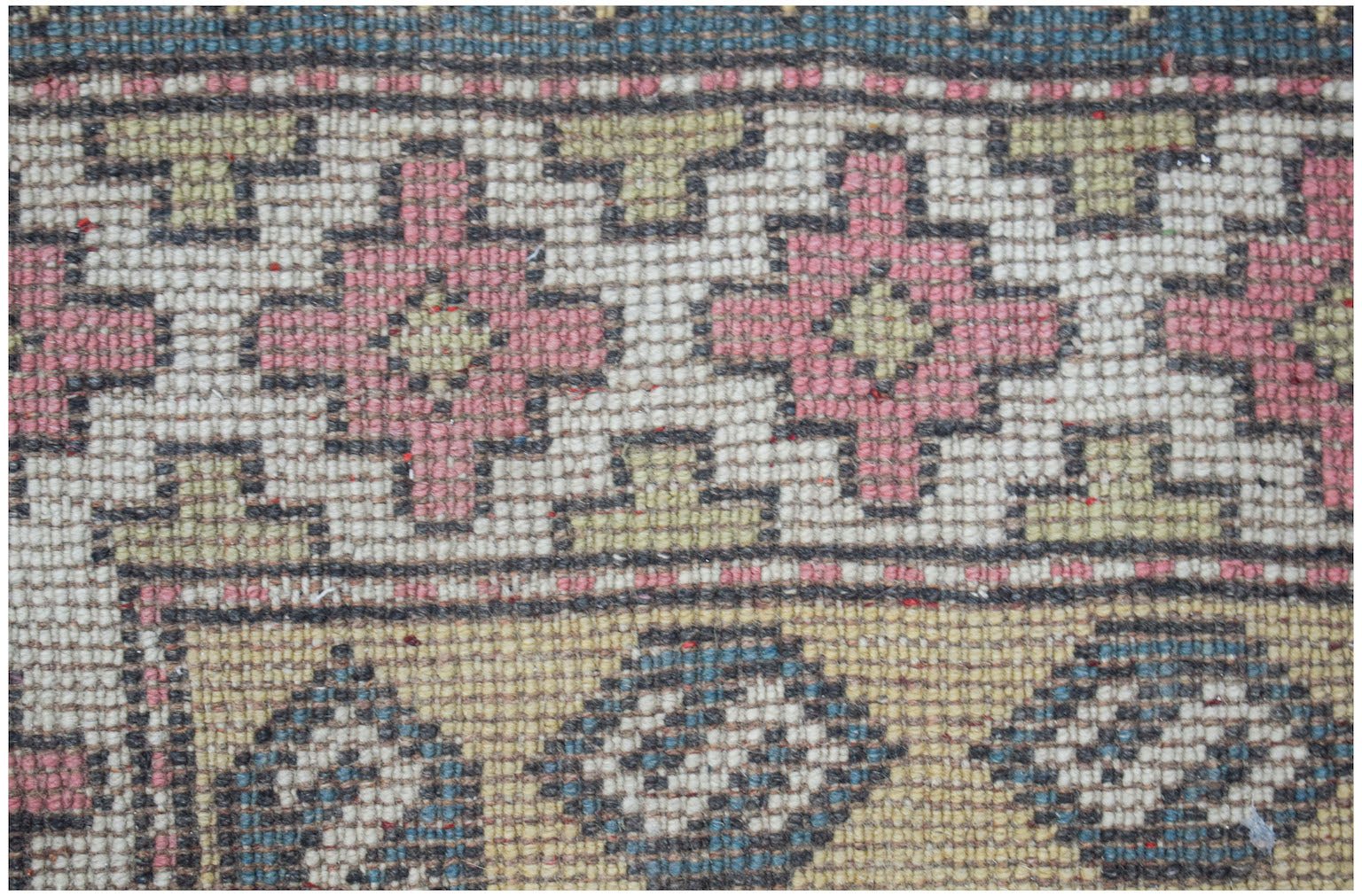 Vintage Turkish Milas rug with geometric patterns in pink, green, and blue.
