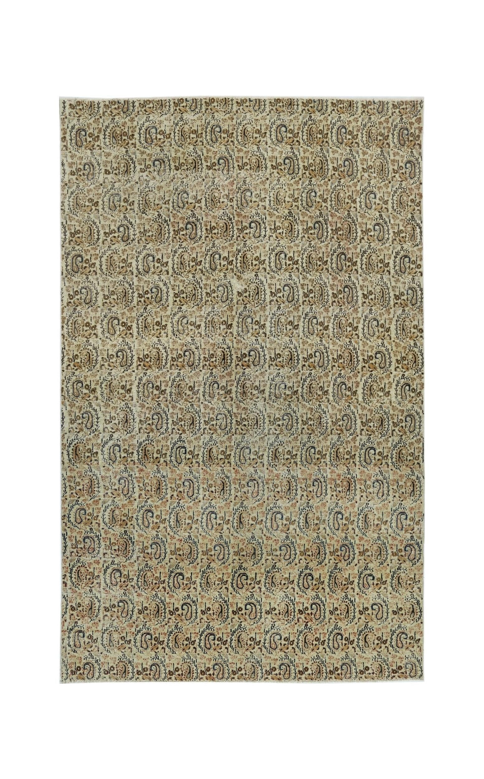 A vintage handmade Turkish rug featuring a repeating paisley pattern in muted earth tones.