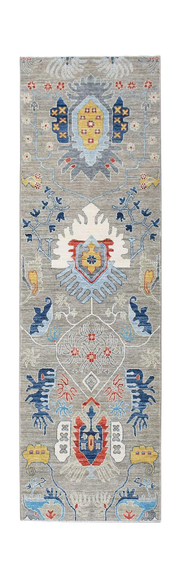An Afghan Chobi runner rug featuring a traditional floral pattern in blue, red, and yellow tones.