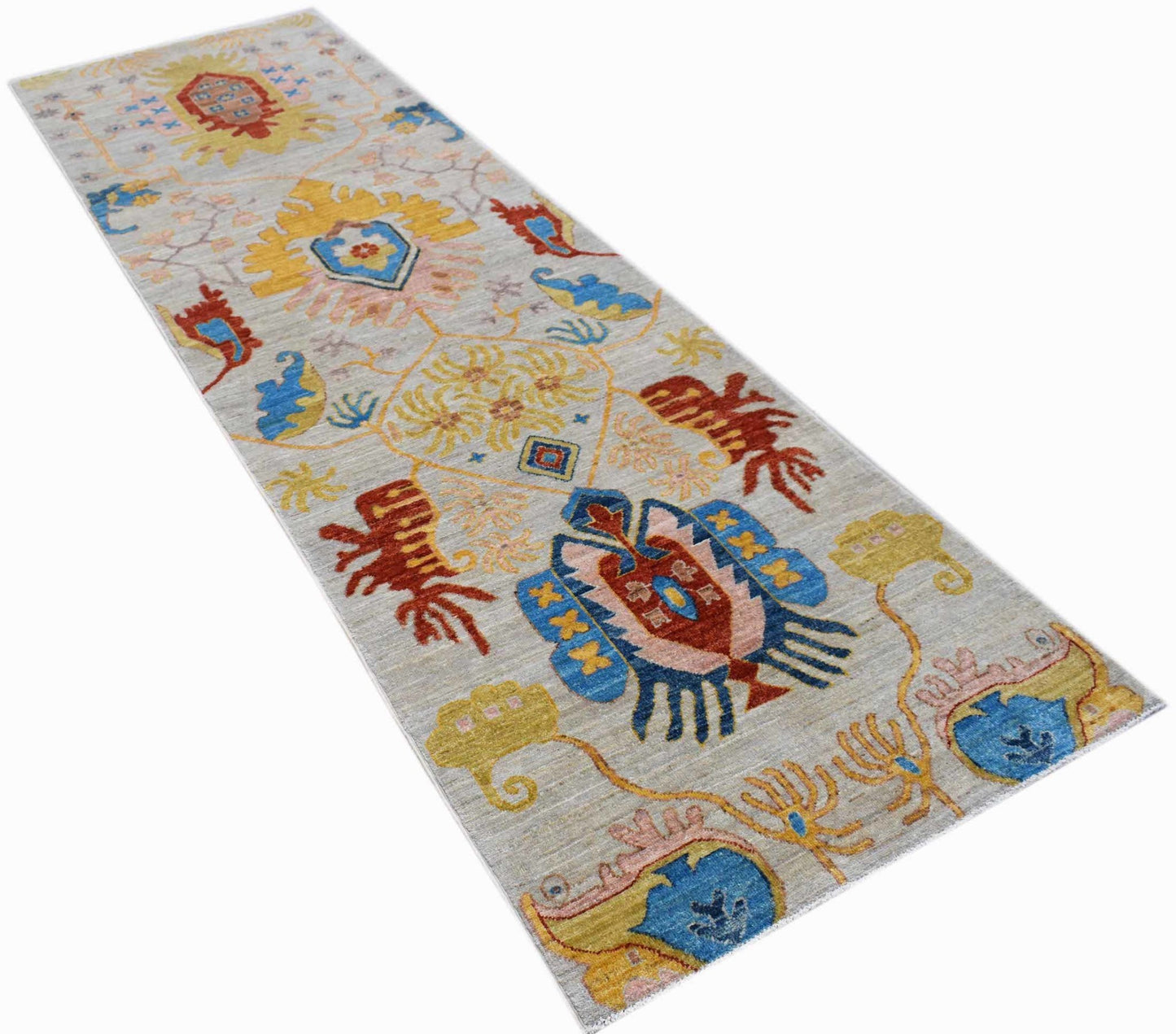 An Afghan Chobi runner rug featuring a light grey field with colorful traditional floral motifs.