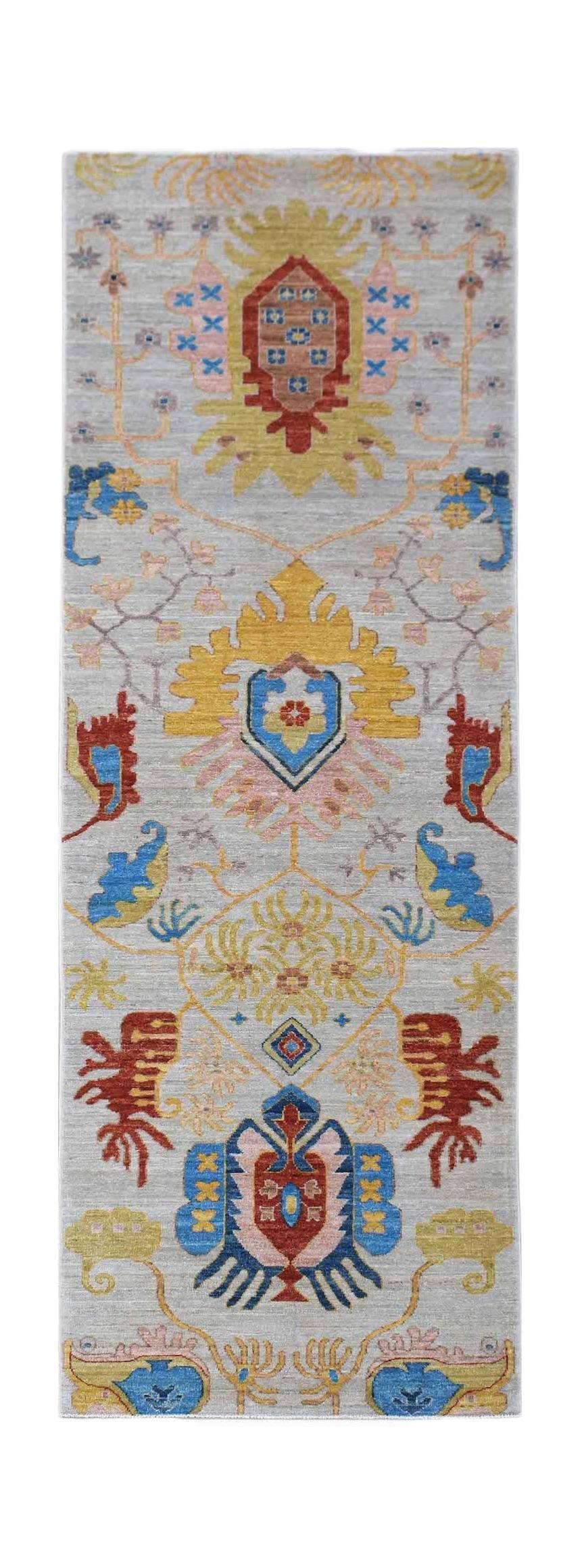 Handwoven Afghan Chobi runner featuring traditional floral motifs in vibrant colors on a grey base.