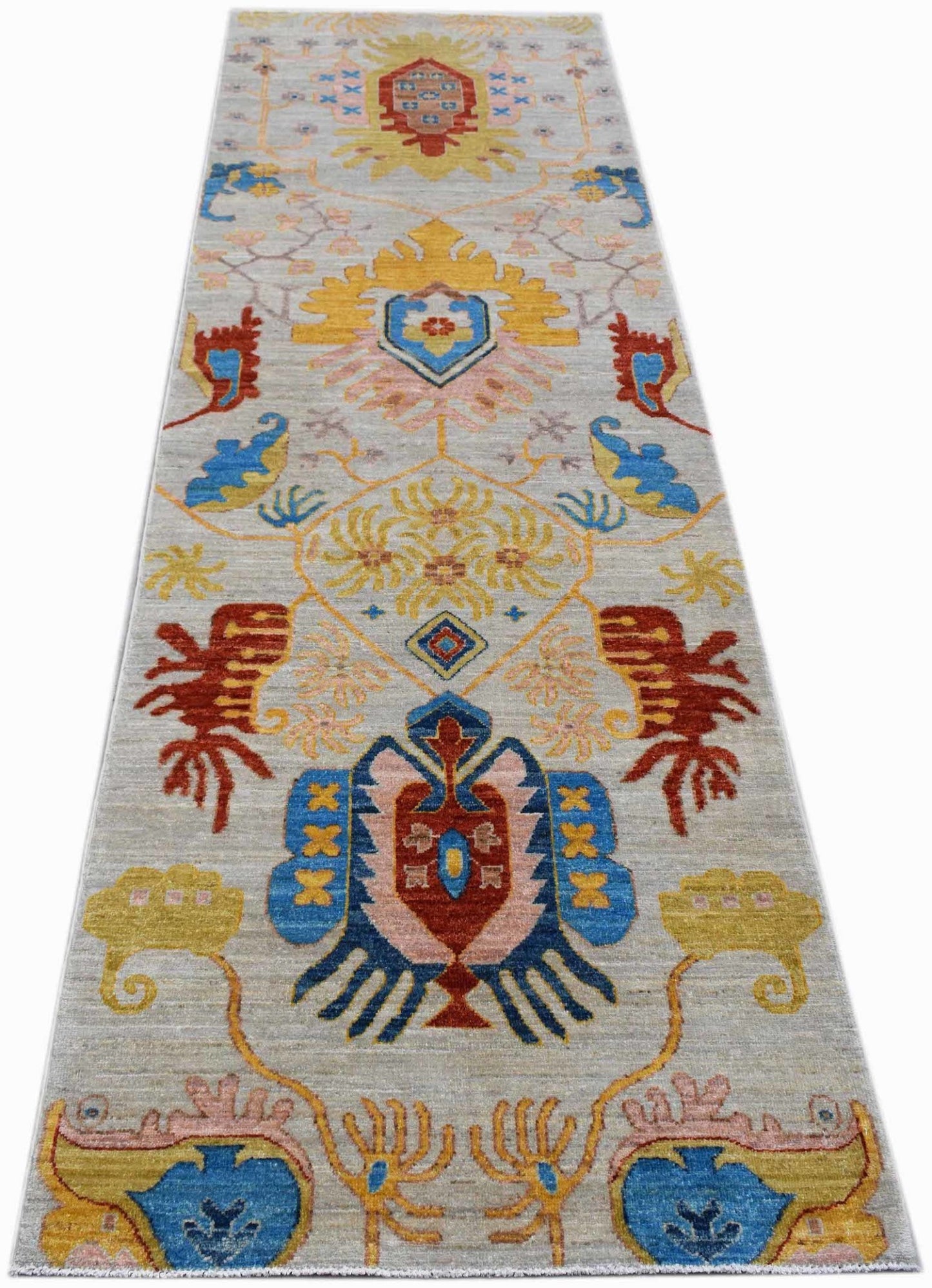 A handwoven Afghan Chobi runner rug featuring traditional geometric patterns in vibrant colors.