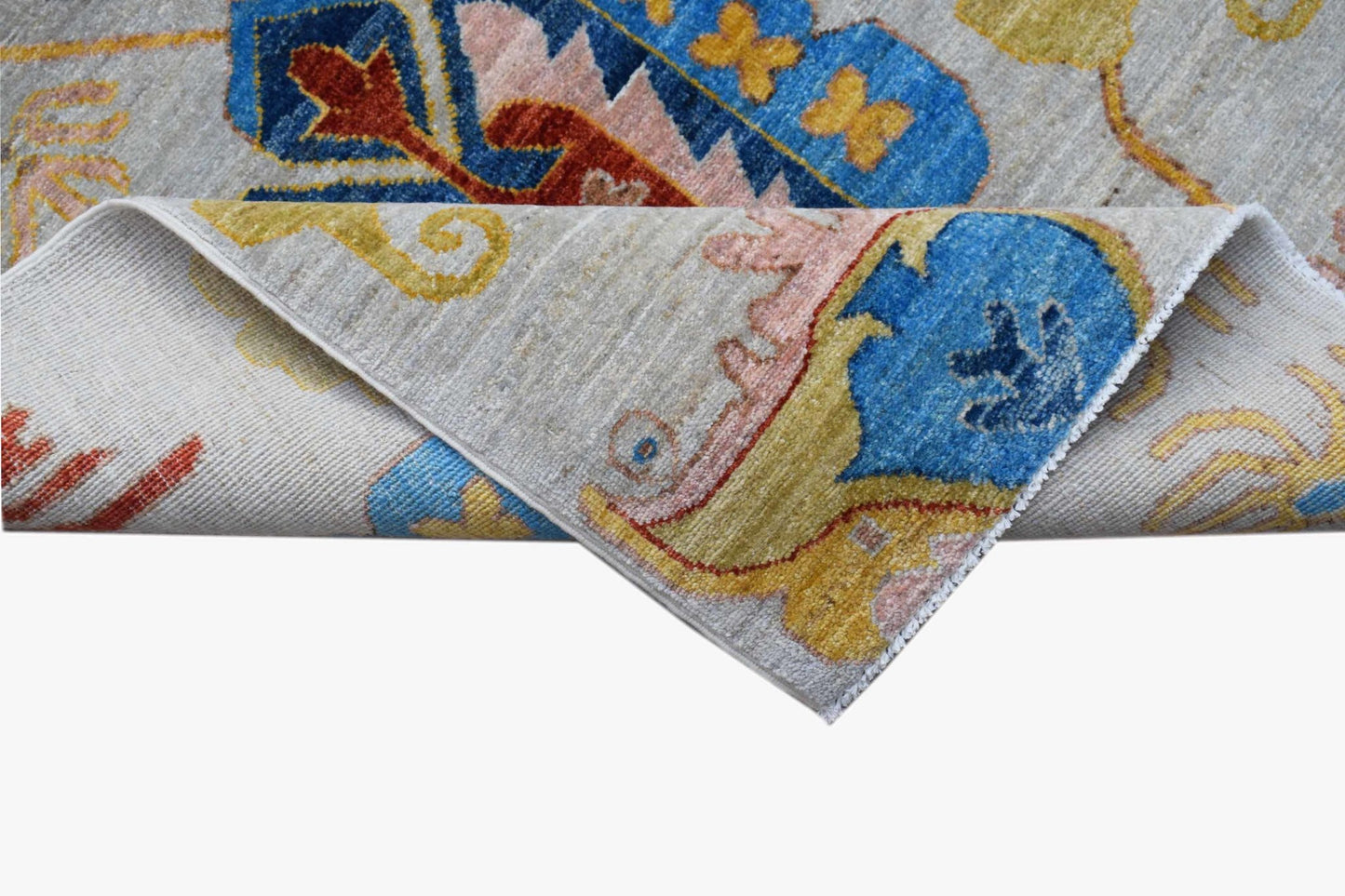 A handwoven Afghan Chobi runner featuring traditional floral patterns in blue, gold, and red.