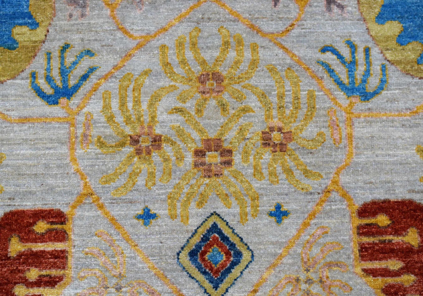 A handwoven Afghan Chobi runner featuring a geometric floral pattern in yellow, blue, and red.