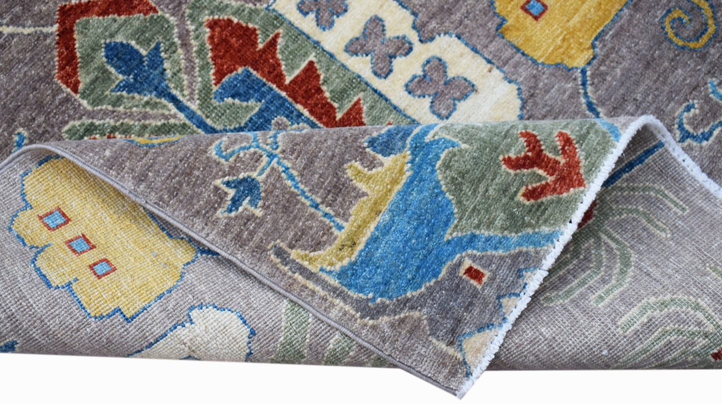 A handwoven Afghan Chobi runner featuring traditional floral patterns in blue, red, and yellow.