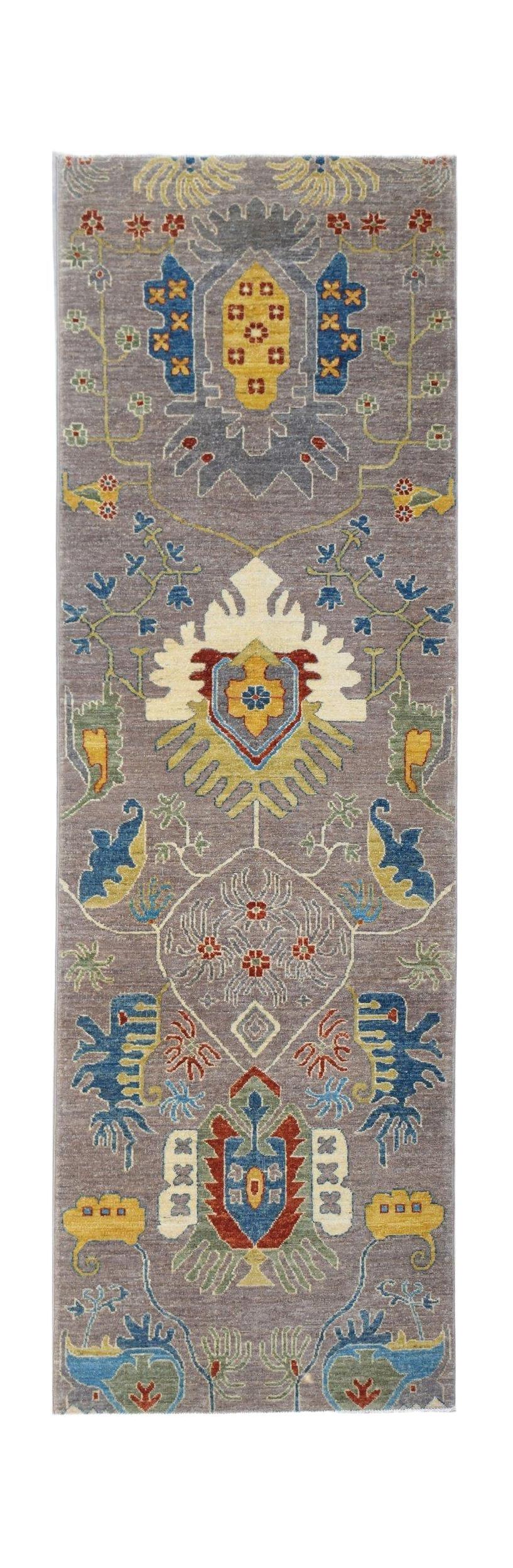A handwoven Afghan Chobi runner featuring traditional floral motifs in muted earth tones.
