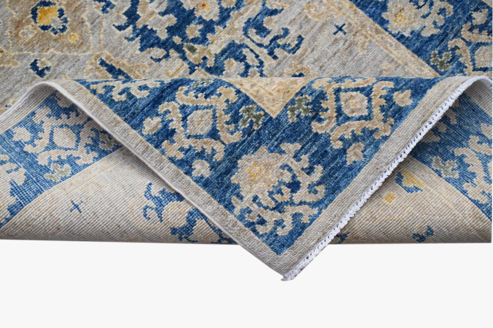 A handmade Afghan Chobi runner featuring a traditional blue and beige floral pattern.