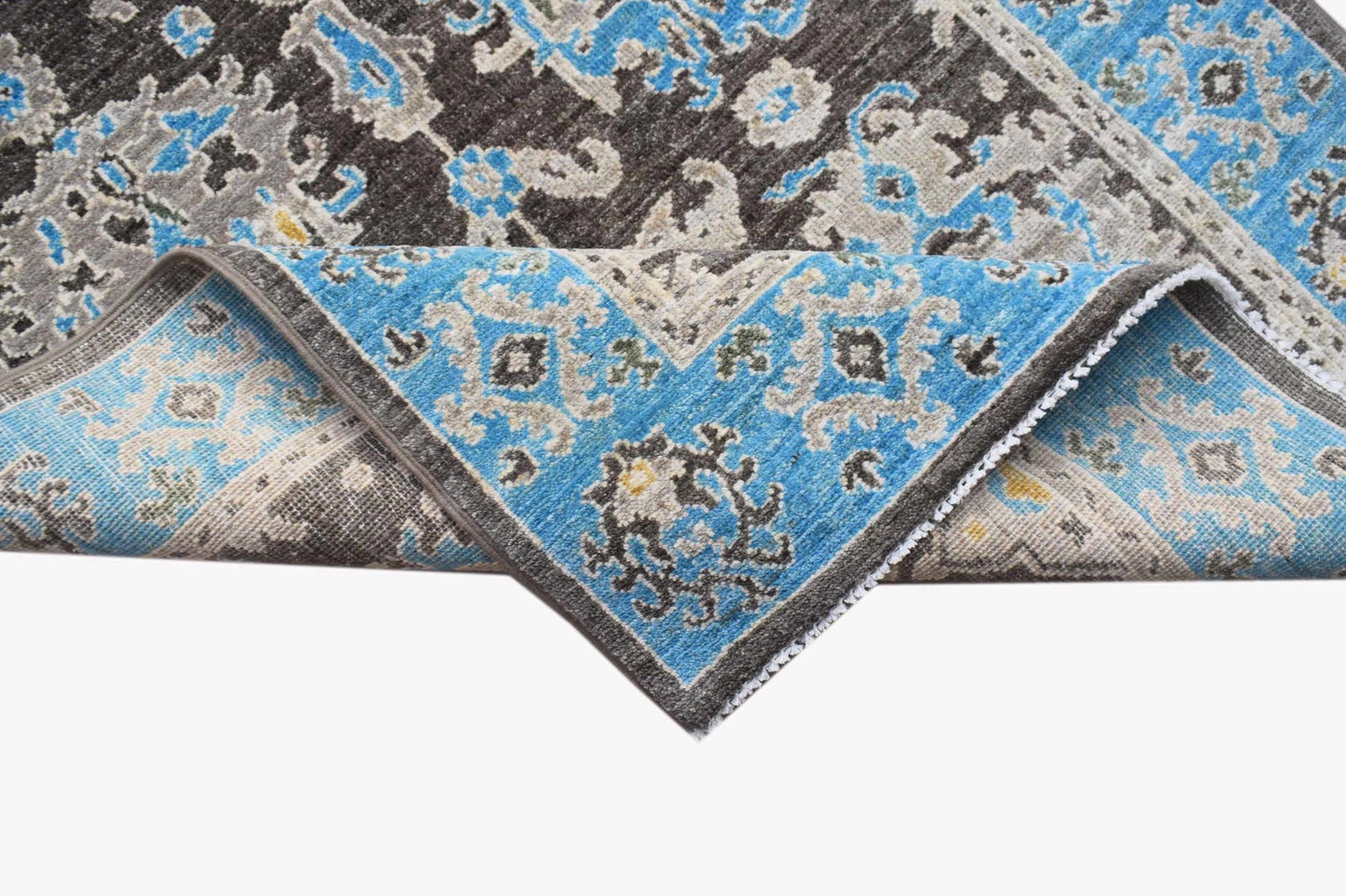 An Afghan Chobi runner featuring a traditional floral pattern in blue, grey, and brown wool.
