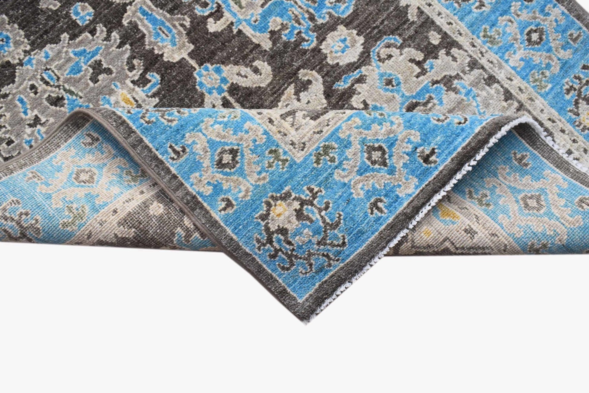 An Afghan Chobi runner featuring a traditional floral pattern in blue, grey, and brown wool.