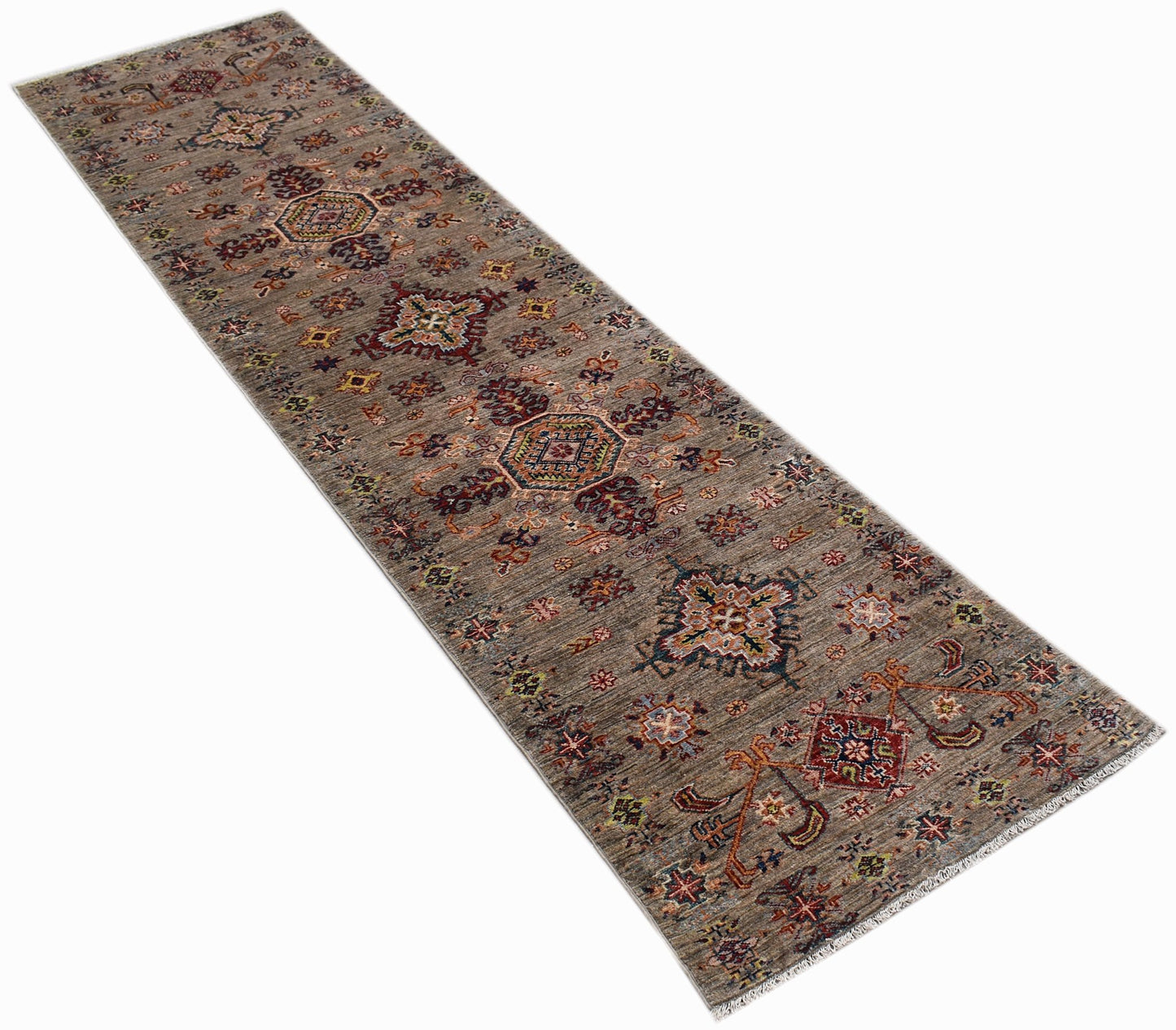 A handmade Afghan Chobi runner rug featuring traditional geometric patterns in earthy wood tones.
