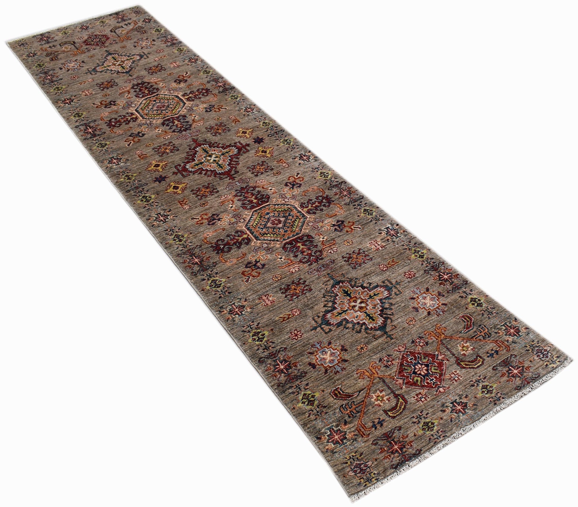 A handmade Afghan Chobi runner rug featuring traditional geometric patterns in earthy wood tones.
