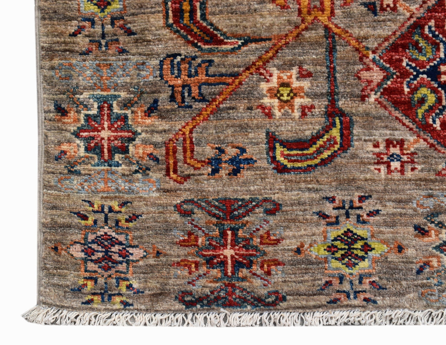 A handmade Afghan Chobi runner featuring traditional geometric patterns in earthy tones.