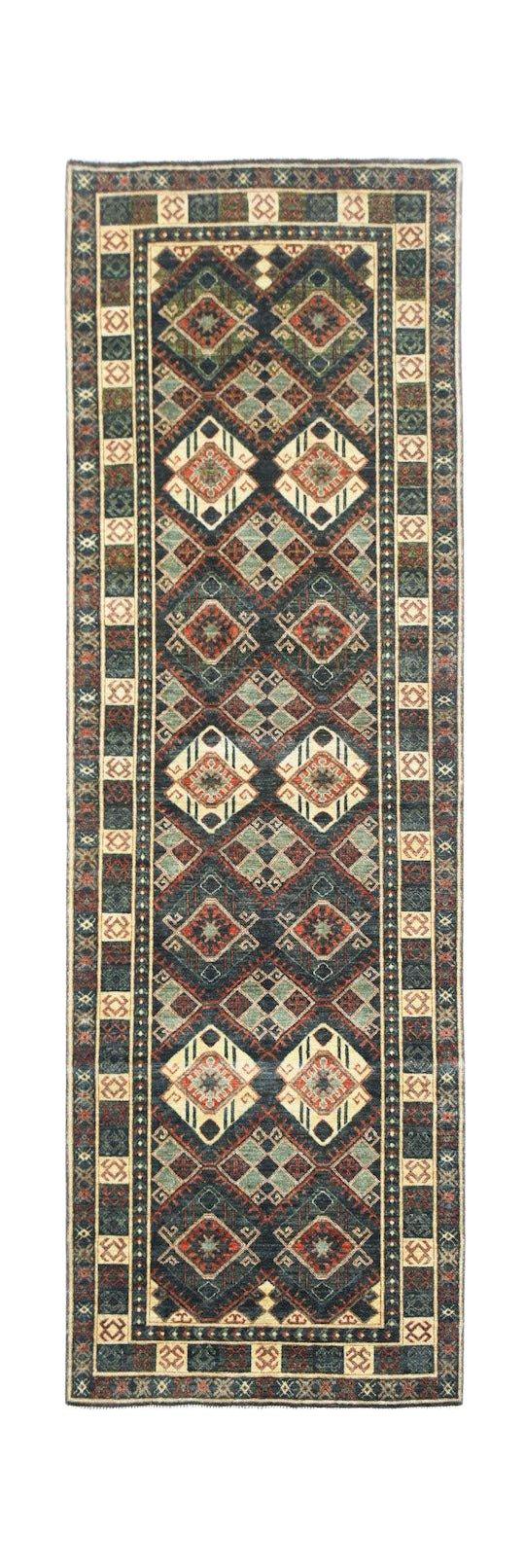 An Afghan Chobi runner rug featuring a geometric pattern in earthy tones on a dark blue background.