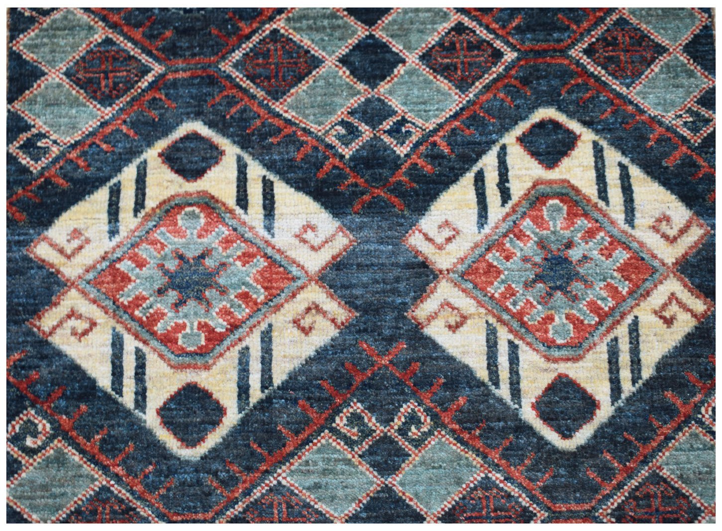 Handwoven Afghan Chobi runner featuring a geometric diamond pattern in blue, red, and cream tones.