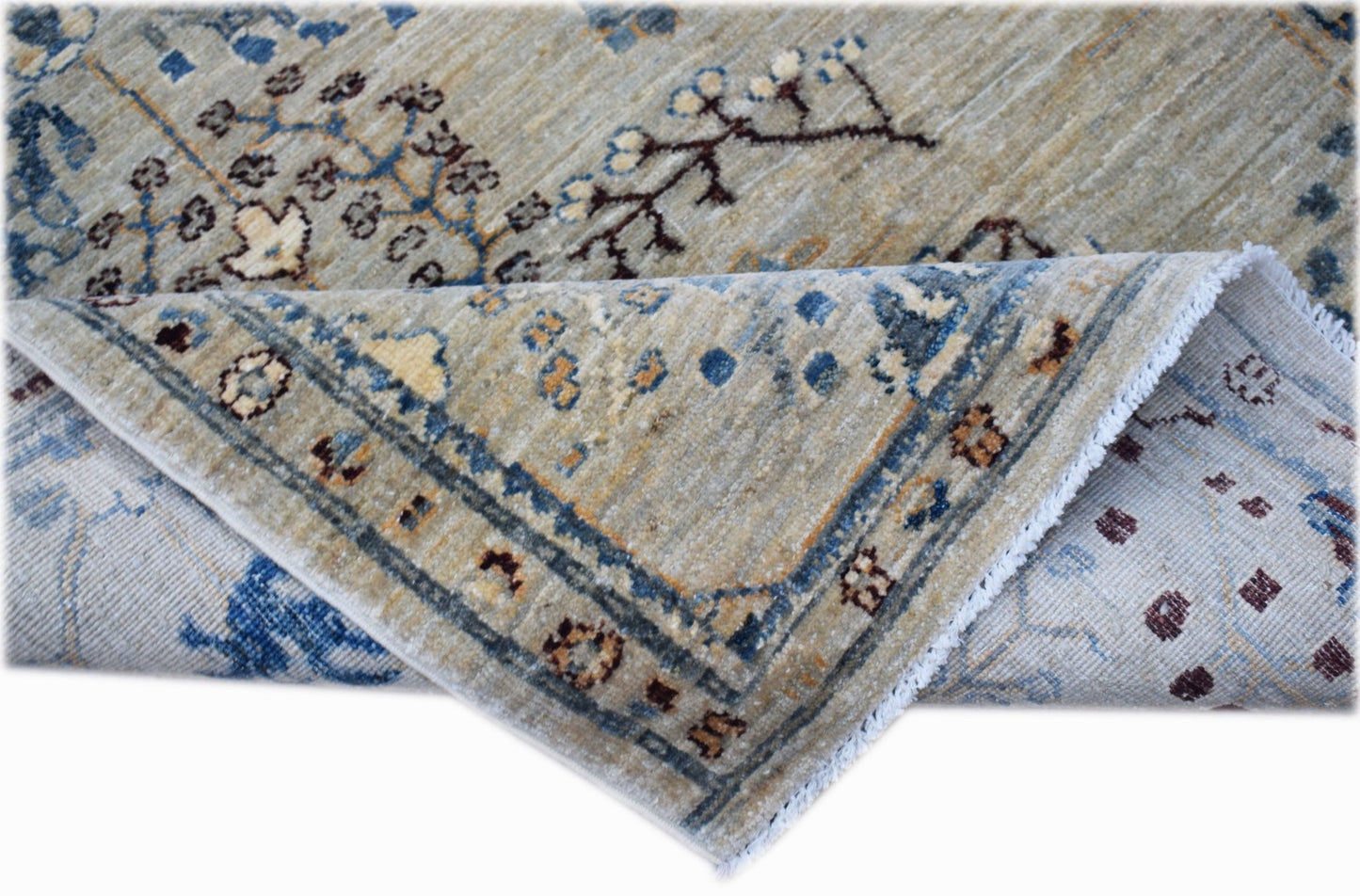 A handwoven Afghan Chobi rug featuring a traditional floral pattern in blue and earthy tones.