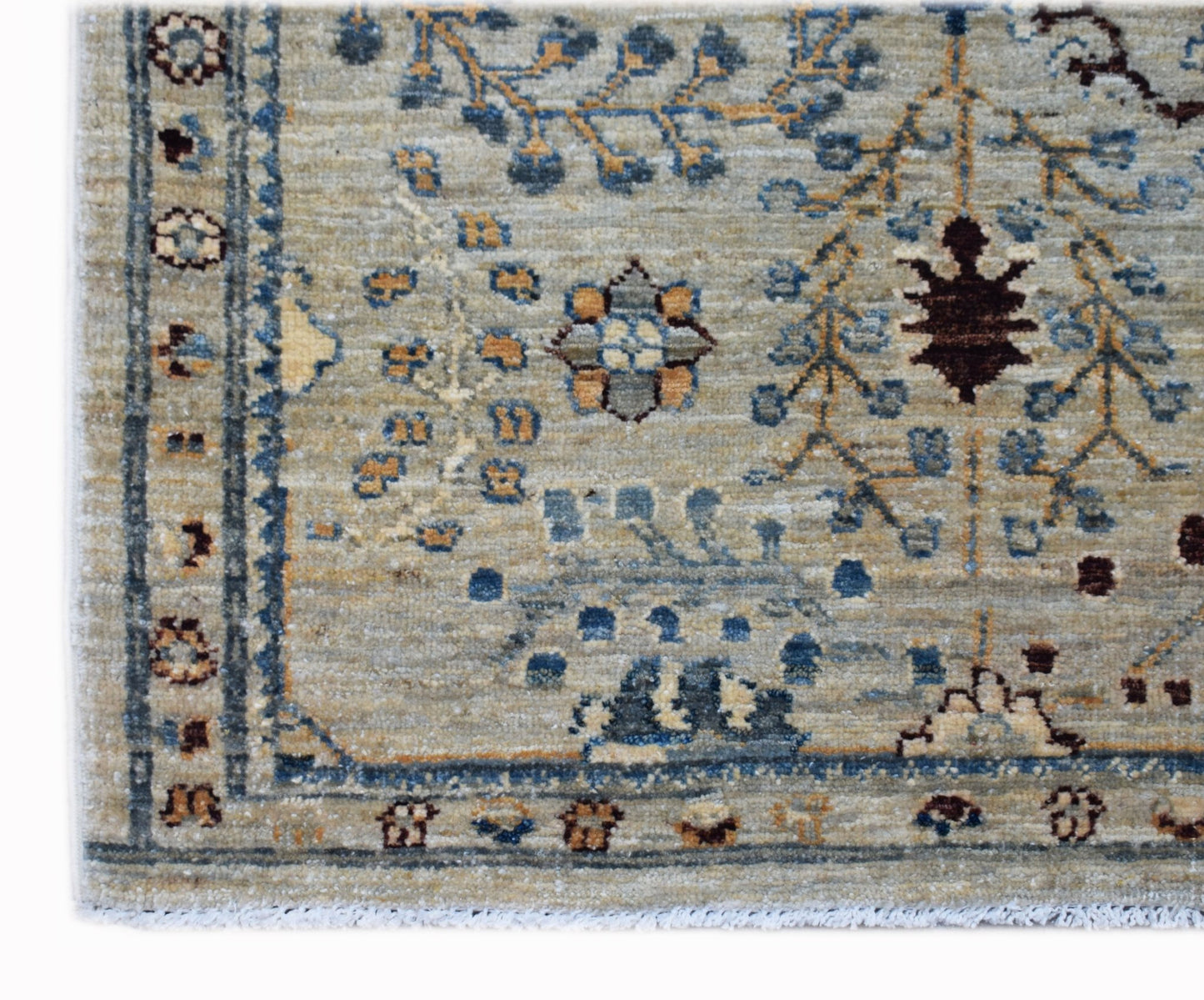 A handwoven Afghan Chobi rug featuring a traditional floral pattern in blue, brown, and beige.